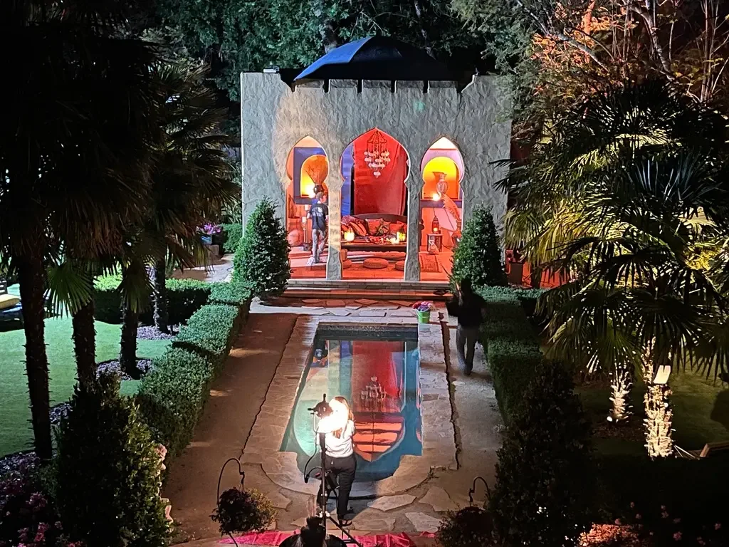 Moroccan-inspired Kasbah staged for nighttime filming at XOHH Events in the Hollywood Hills, Los Angeles, with illuminated arches and production lighting reflected in the pool.