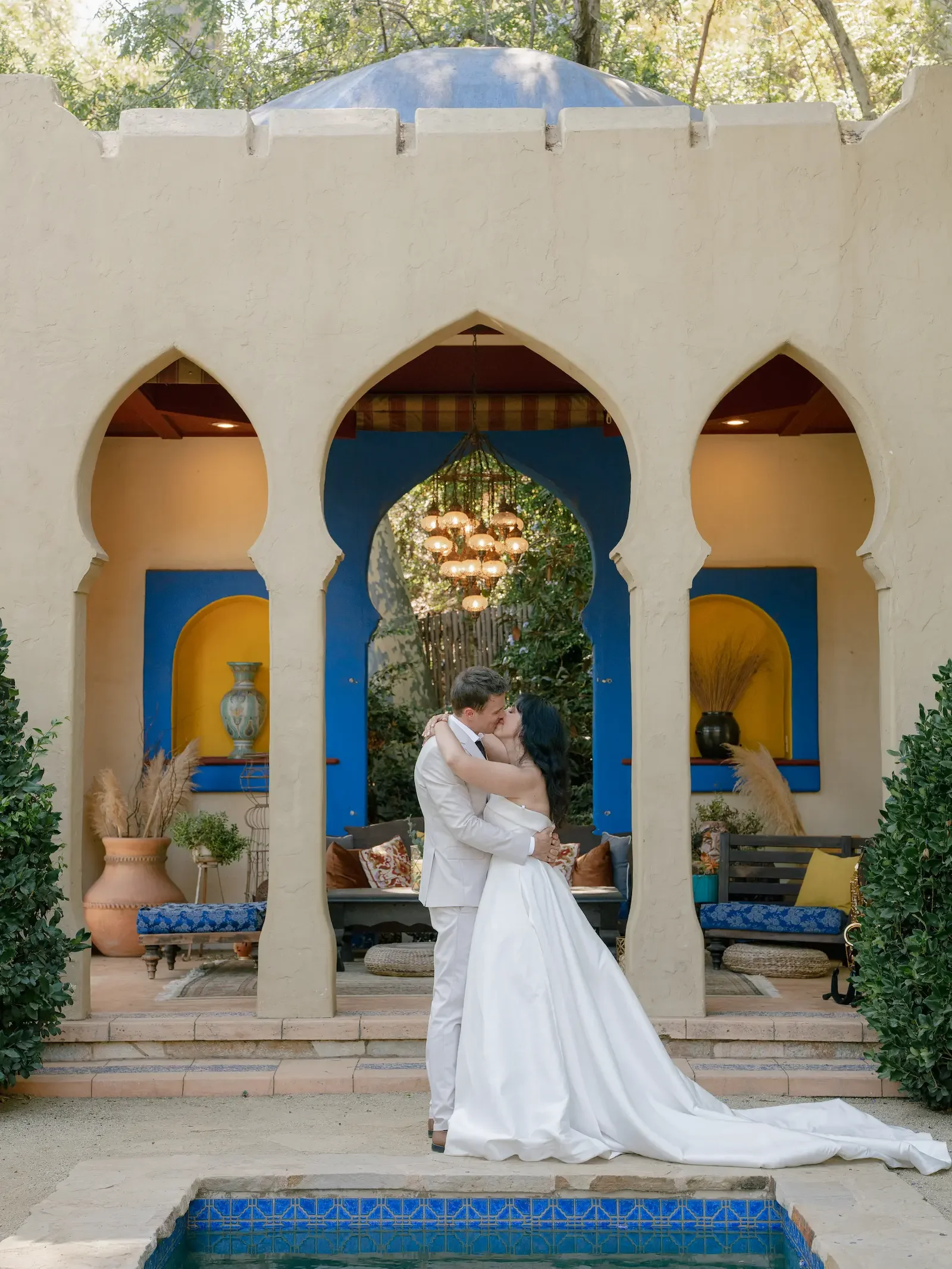 Bride and groom embracing in front of the Kasbah after their wedding ceremony.