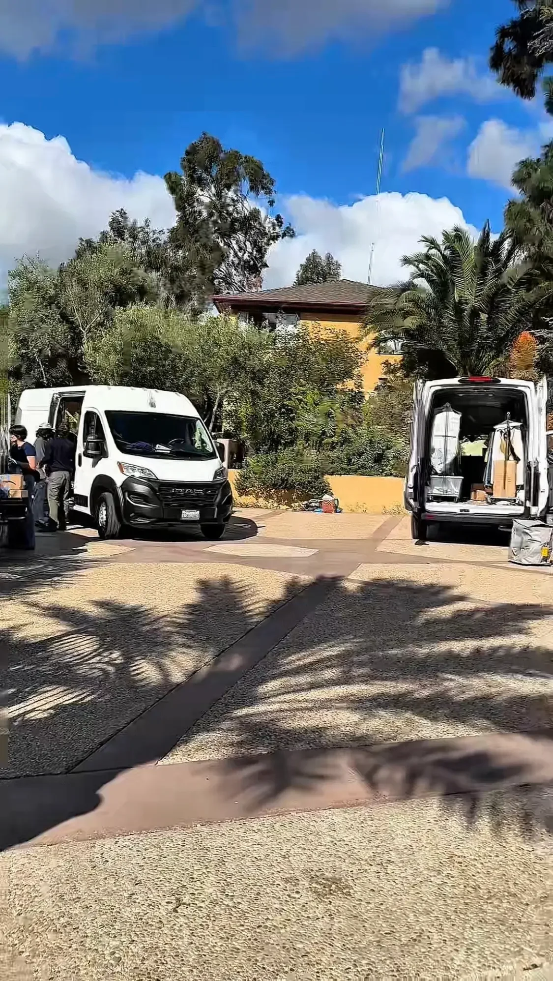 Production vehicles parked on the estate driveway at XOHH Events, a private film location in Los Angeles.
