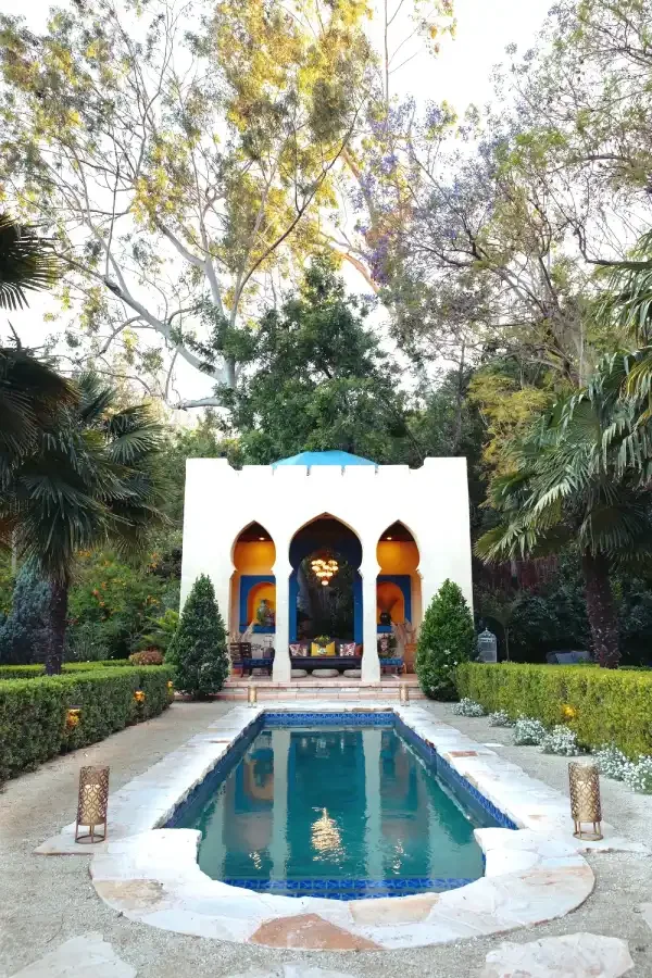 Moroccan-inspired Kasbah overlooking a blue-tiled pool, surrounded by lush gardens at XOHH Events in the Hollywood Hills.