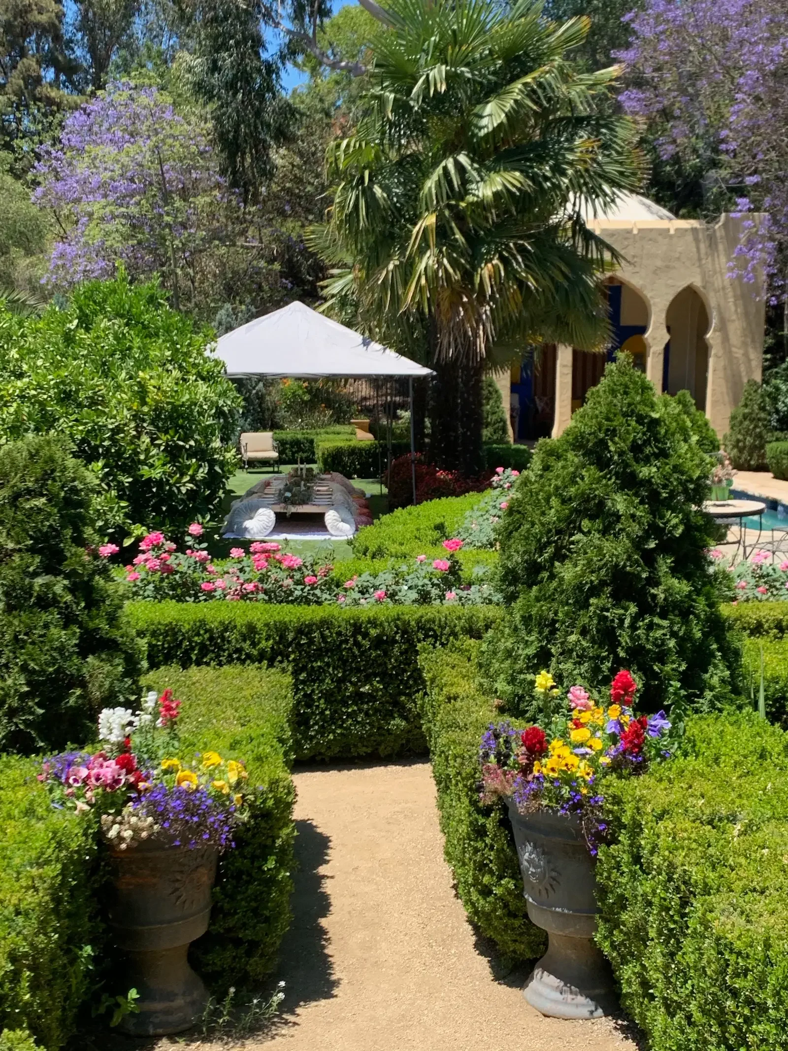 Lush garden pathway and fountain surrounded by greenery at XOHH Events in the Hollywood Hills