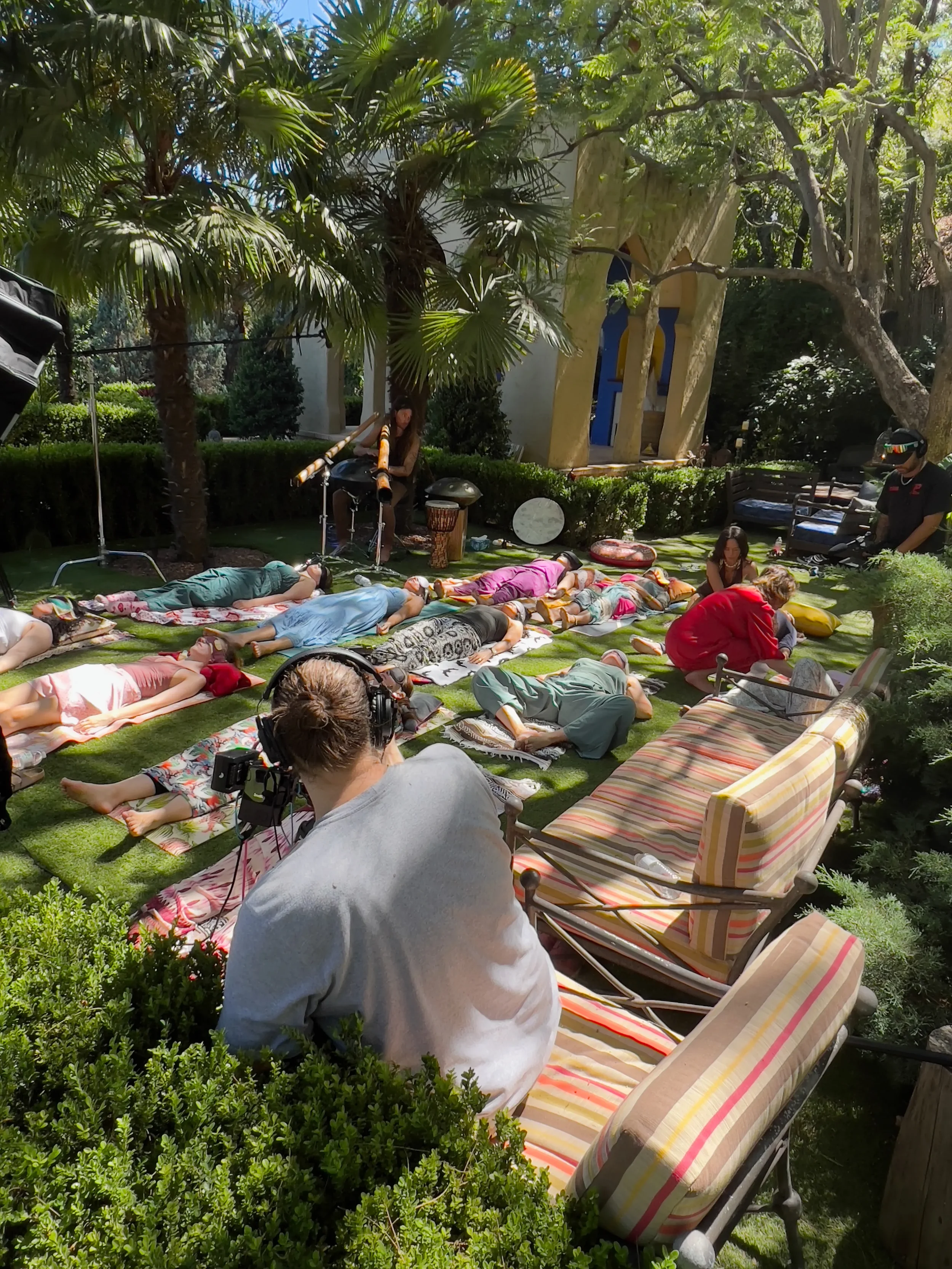 Film crew on the Moroccan lounge cushions with a camera operator
