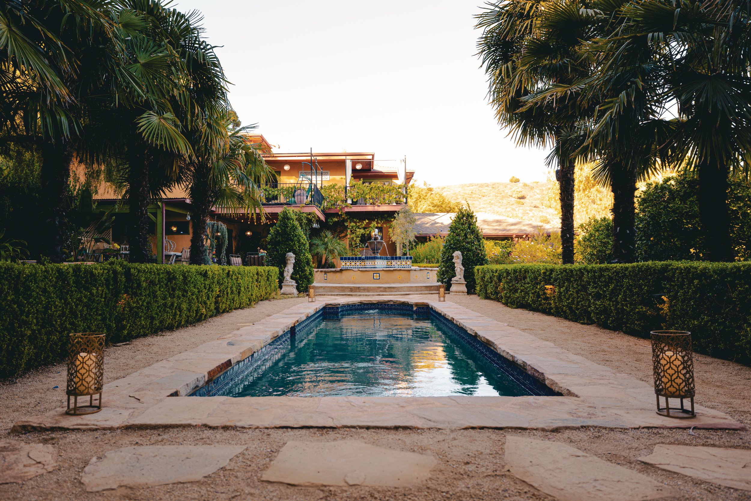 Private outdoor event venue in the Hollywood Hills featuring the XOHH Events pool, lush gardens, hillside home and surrounding open hills, viewed from the Moroccan-inspired Kasbah.