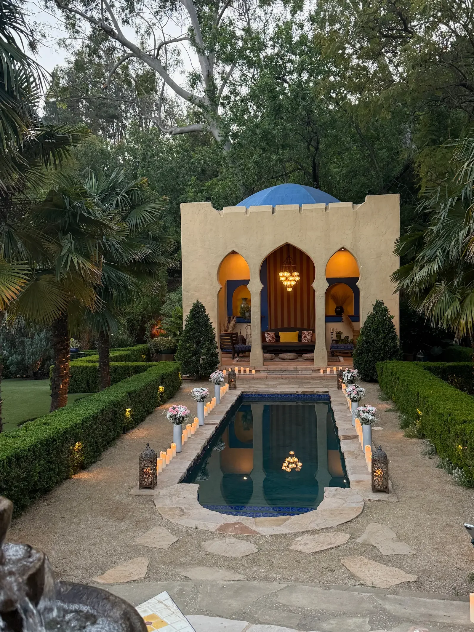 Romantic wedding proposal setup by the Kasbah and pool with candlelight at XOHH Events.