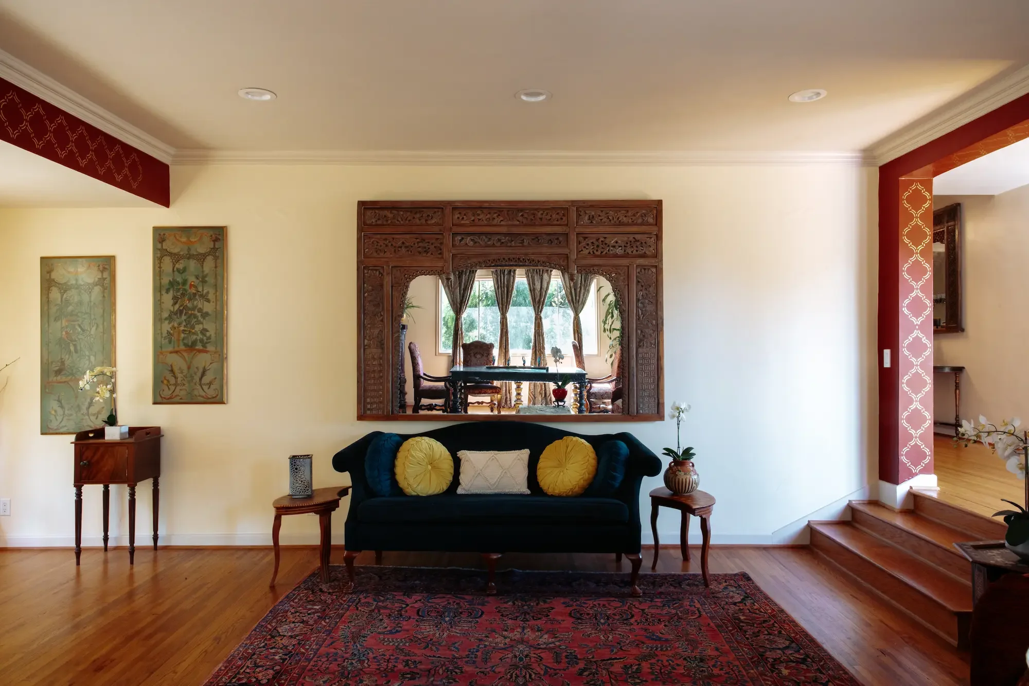 Elegant sofa and oversized decorative mirror inside the Grand Salon at XOHH Events in the Hollywood Hills.