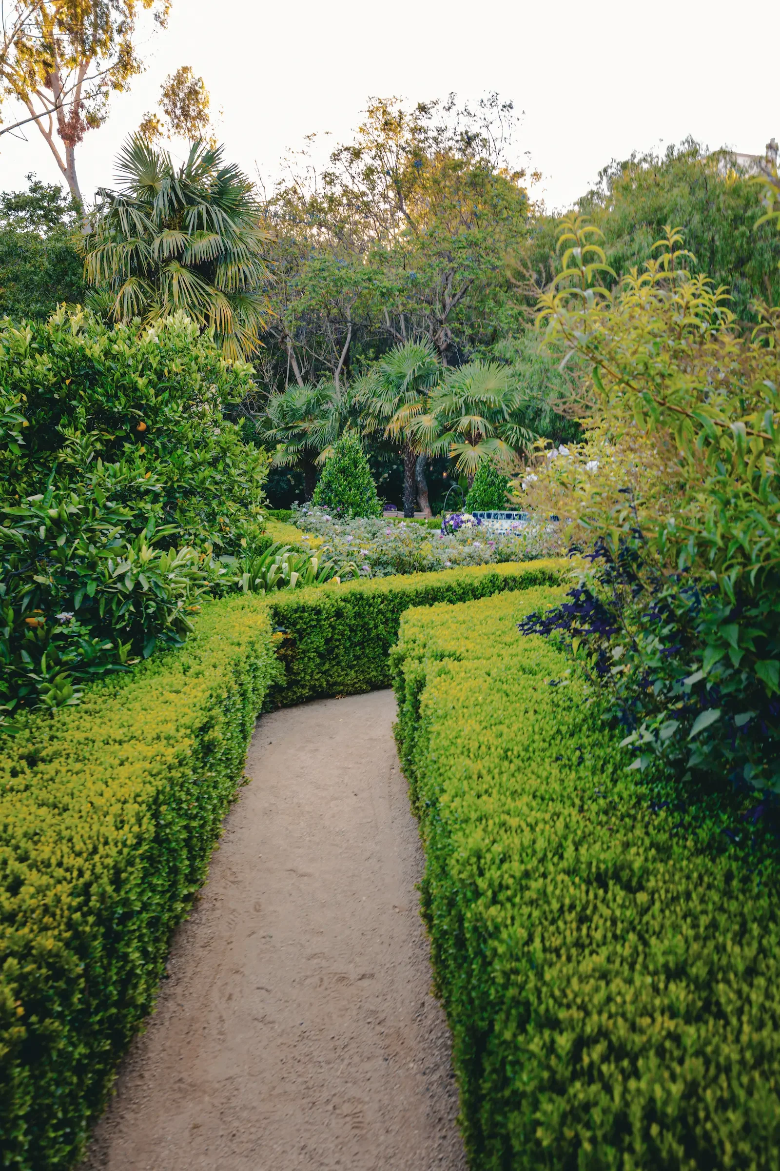 Landscaped garden pathway connecting the front and rear areas of the private Hollywood Hills estate.