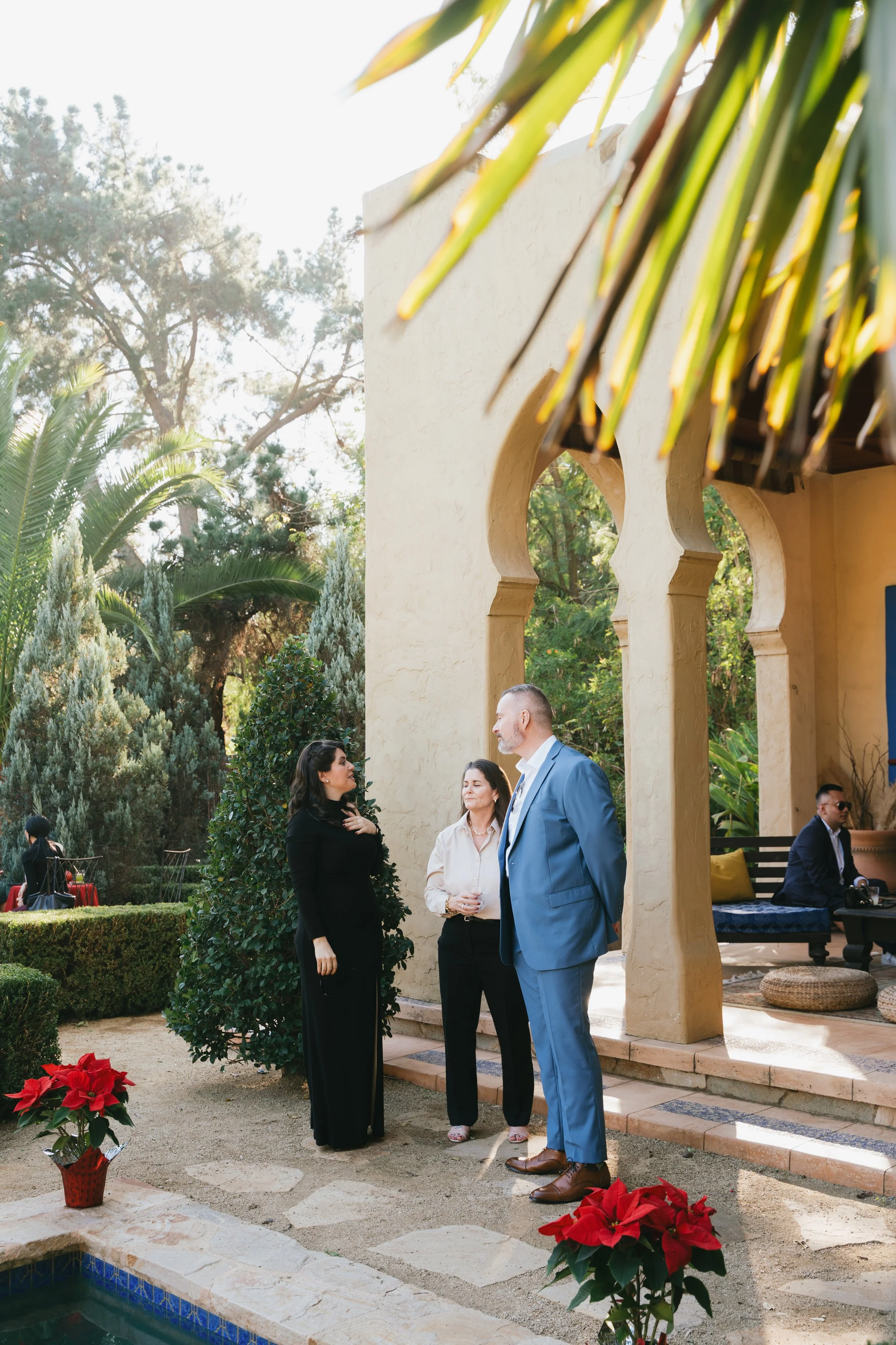 Two guests in conversation beside the Moroccan archways