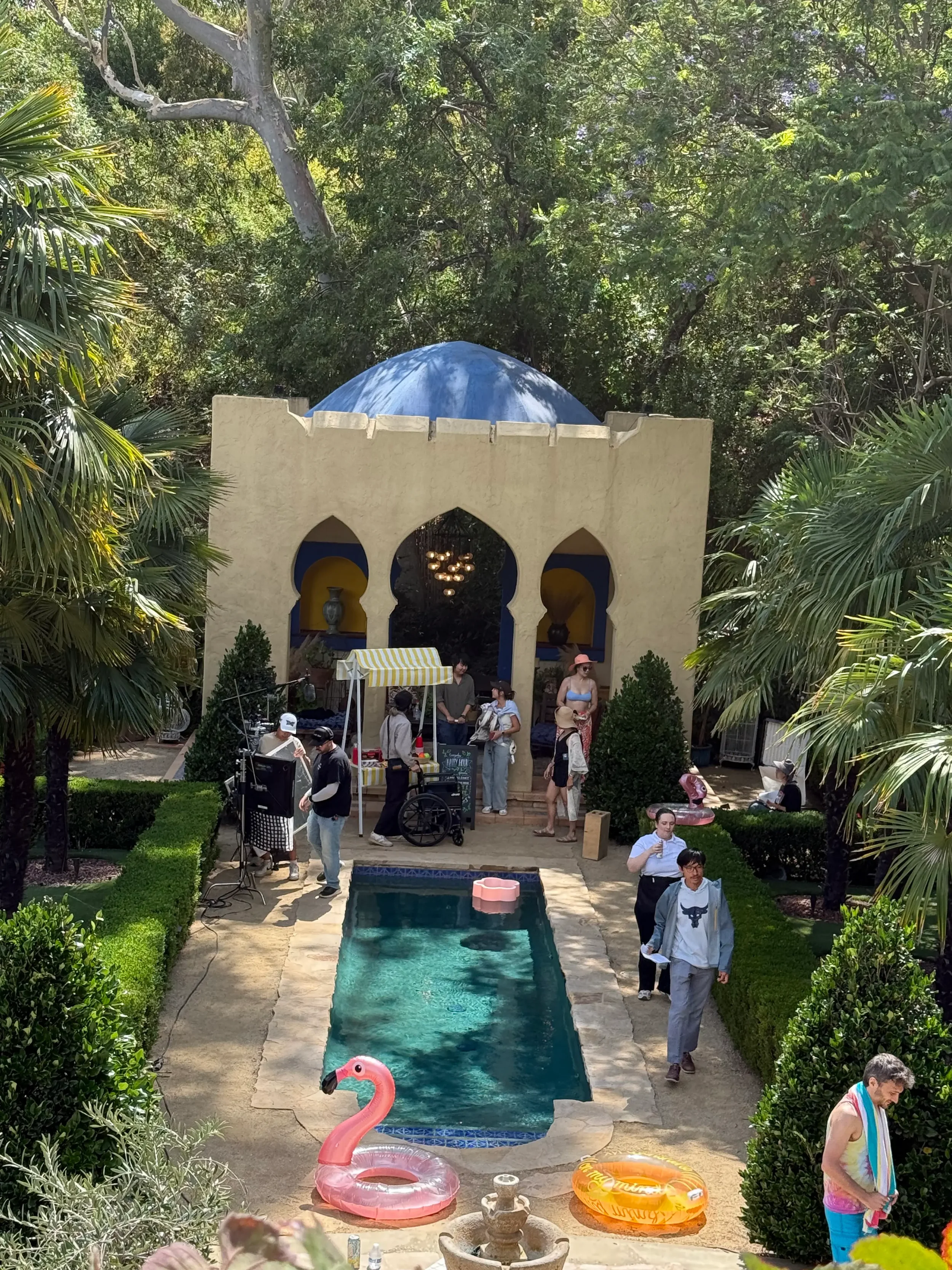 Cast and crew filming beside the pool and Moroccan-inspired Kasbah at XOHH Events, a private Hollywood Hills filming location in Los Angeles.