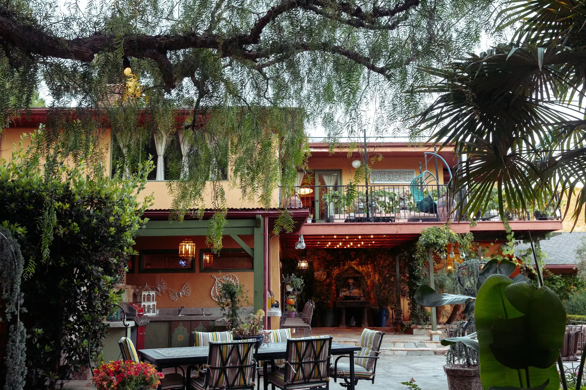 View from the garden toward the estate’s patios and upper decks at XOHH Events in the Hollywood Hills.