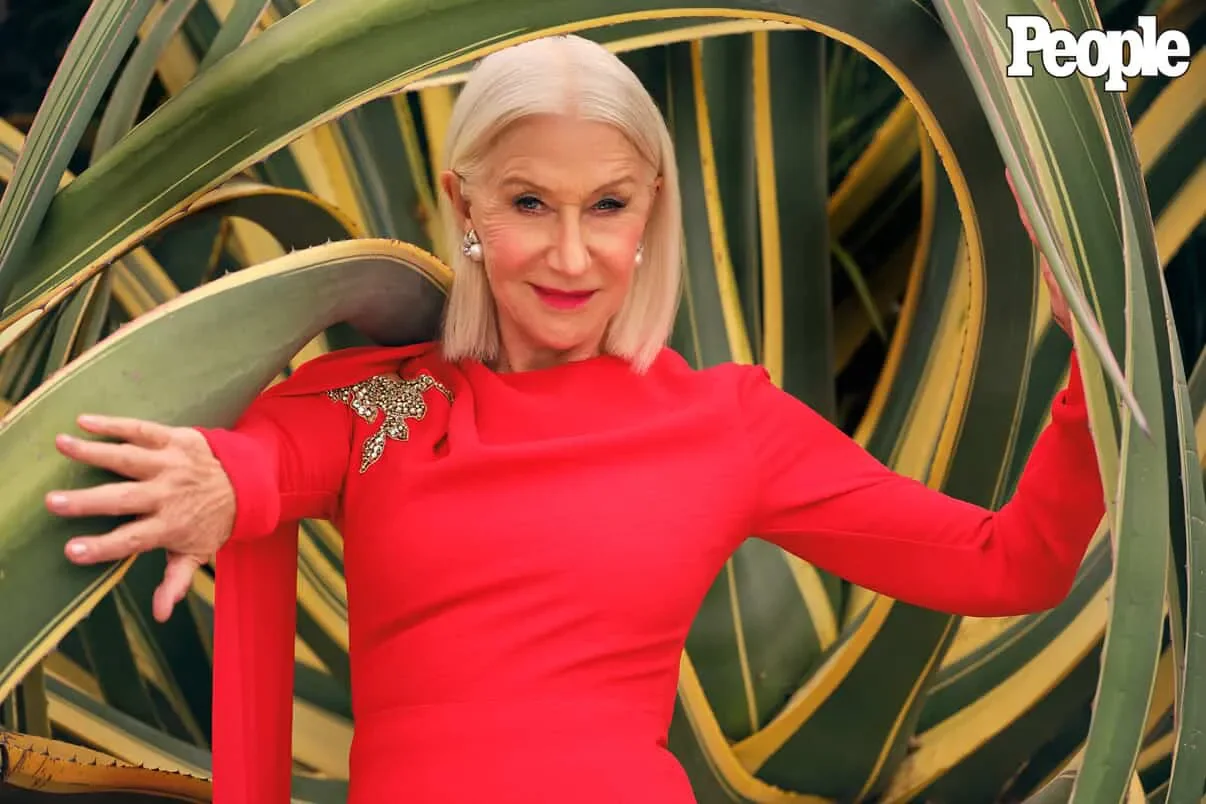 Editorial portrait in red before a large agave and palms