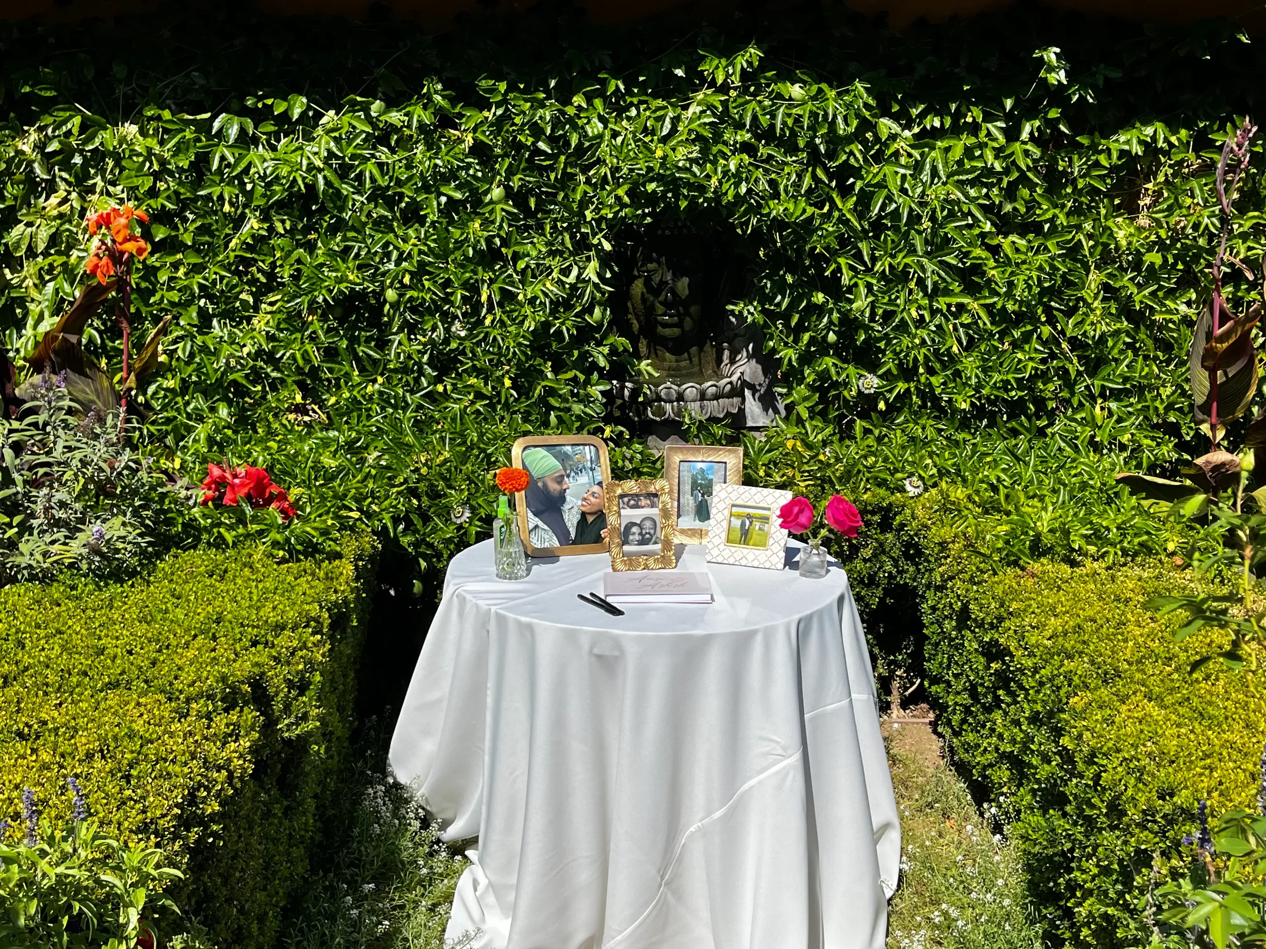 Long white-linen dinner table set against a cobalt Moroccan wall