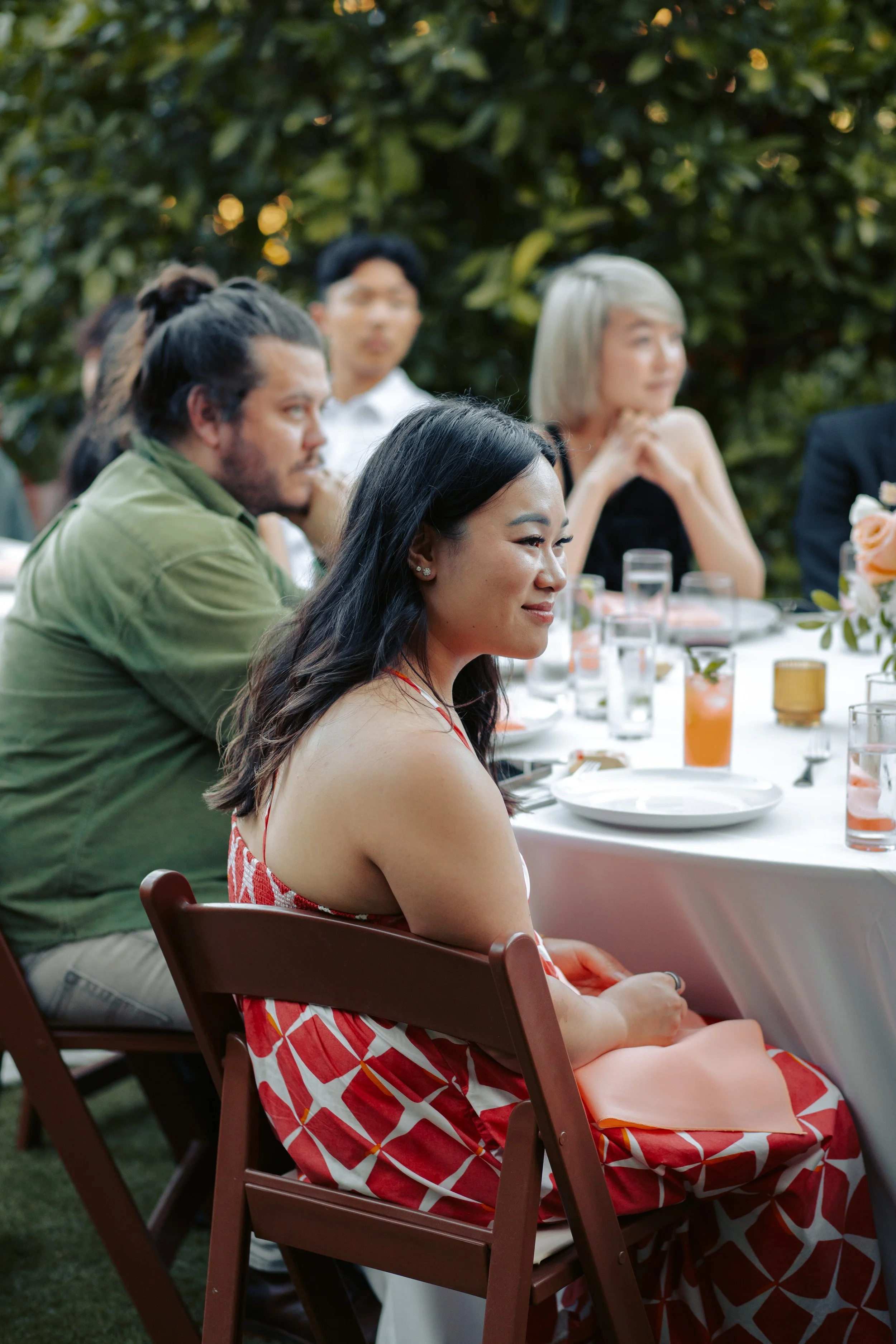Guests in conversation at an outdoor garden reception table