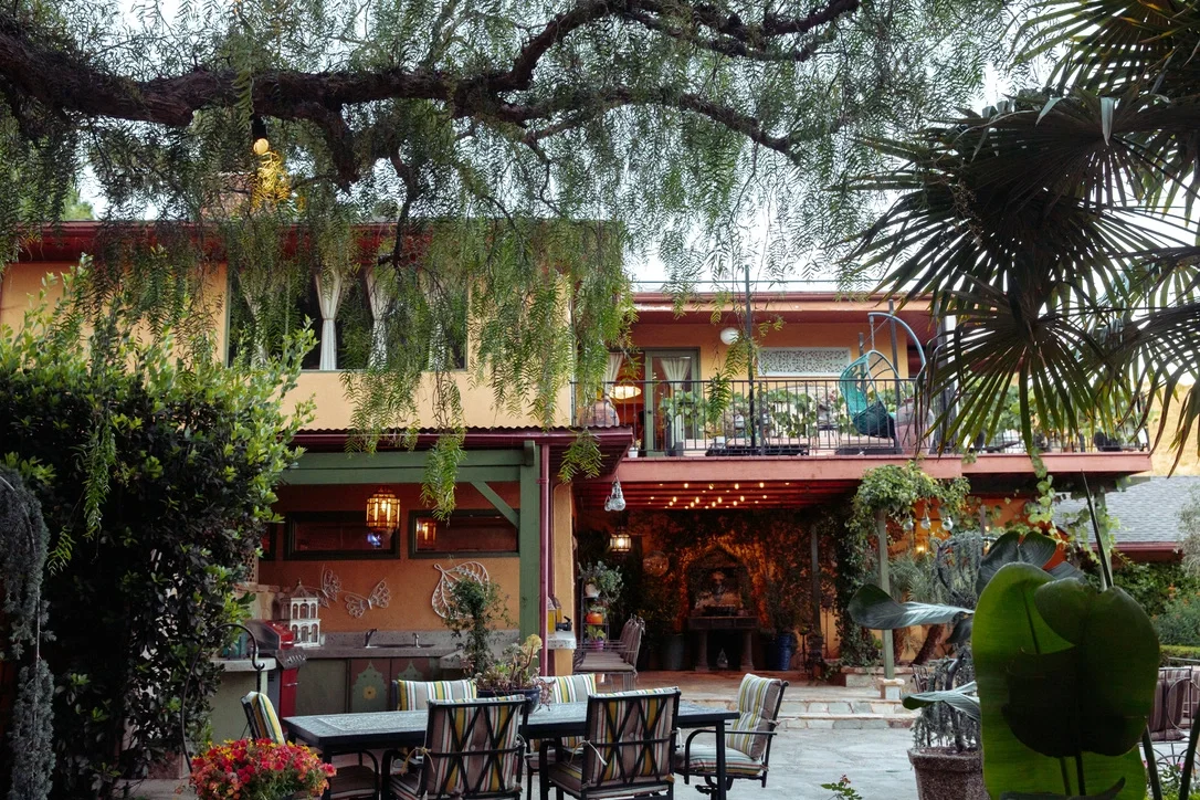 Moroccan-style building glowing at dusk with an outdoor lounge under warm string lights