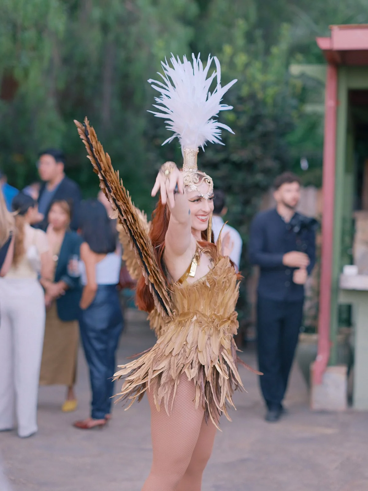 Carnival dancer in a feathered costume entertaining guests