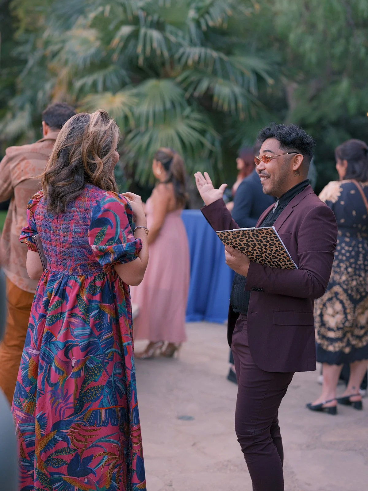 Event coordinator with a clipboard greeting arriving guests