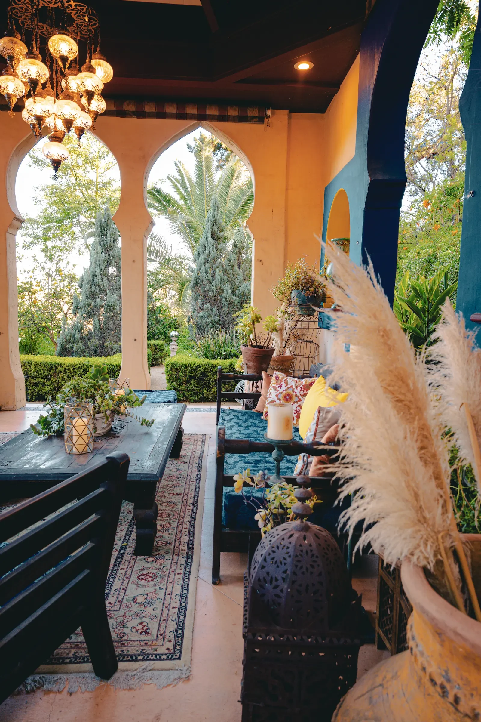 Inside the Moroccan-inspired Kasbah, looking through a row of open arches toward the side garden.