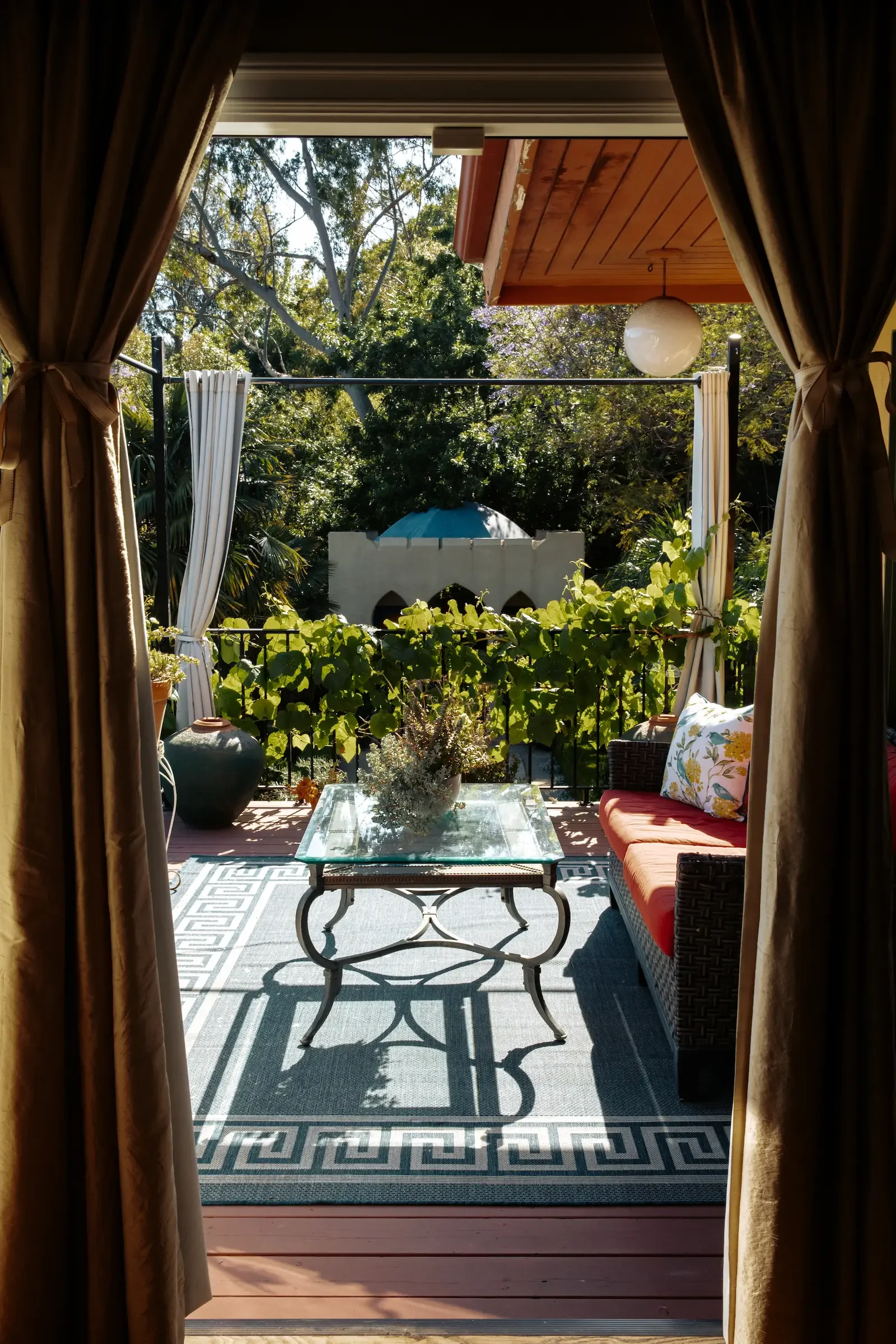 View from the family room through the outdoor deck and landscaped gardens toward the Moroccan-inspired Kasbah.