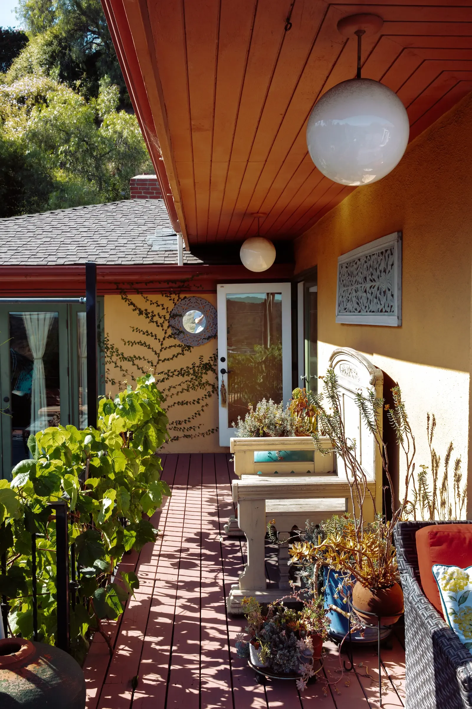 Private outdoor deck with seating and mature landscaping, connecting both decks available for filming and production use.