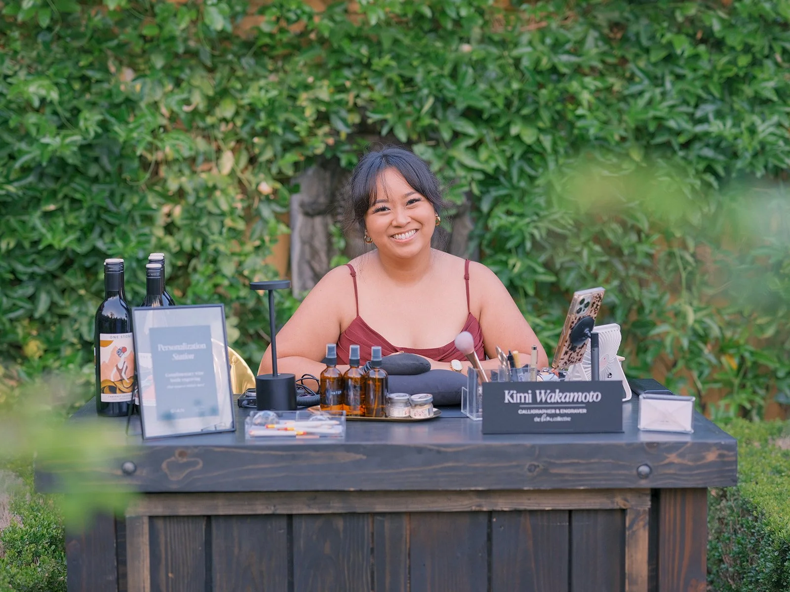 Host at a "Kimi Wakamoto" tasting station lined with bottles