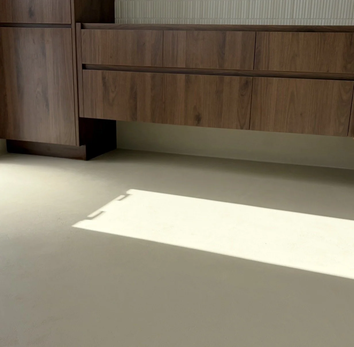 Microcement bathroom interior feature with a seamless oat finish by Surface Revival Auckland.