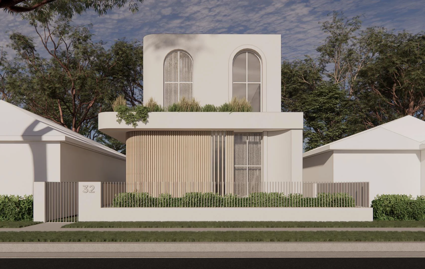 Modern two-story white house with curved balcony and large arched windows, surrounded by a metal fence and greenery, with trees in the background under a partly cloudy sky.
