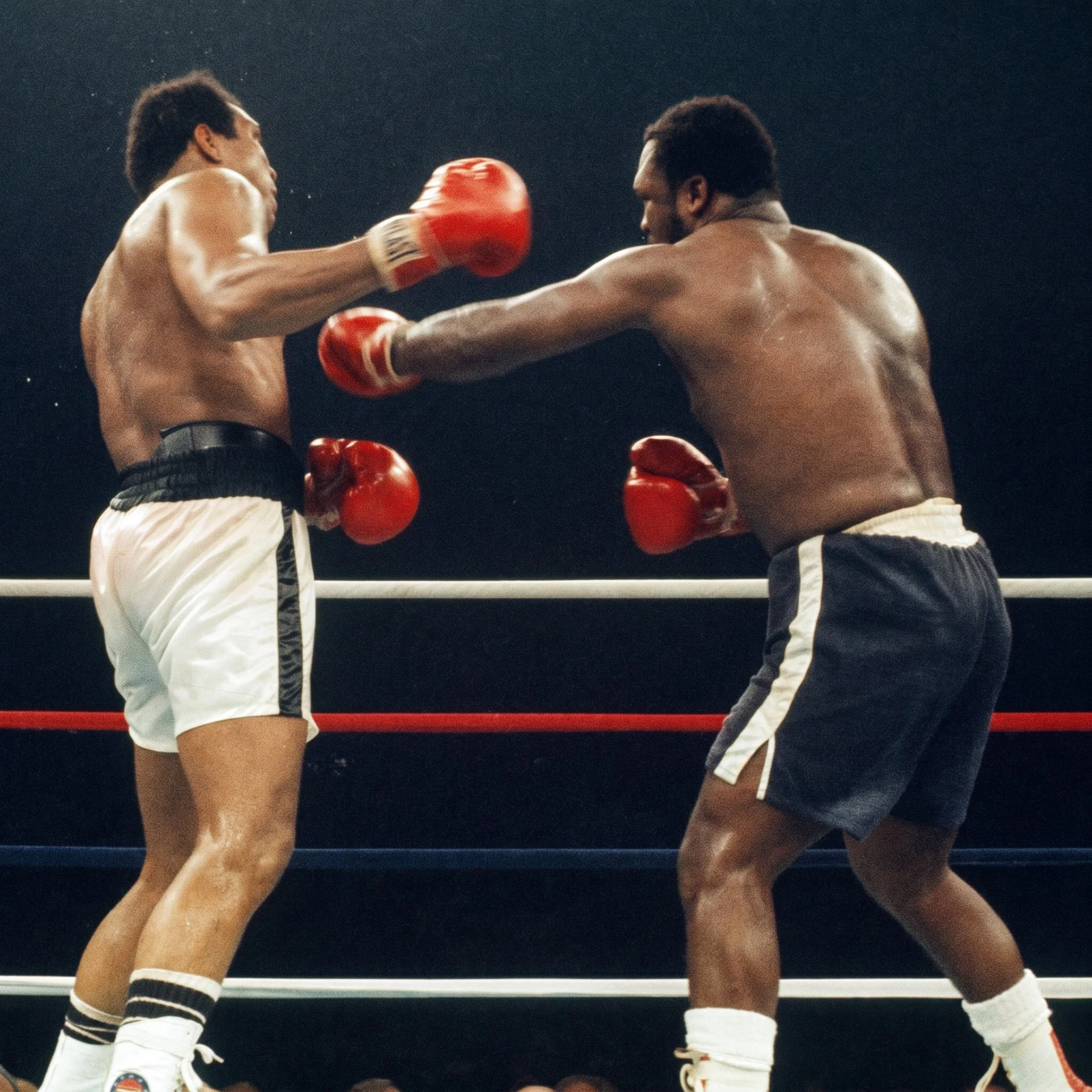 Joe Frazier lands a left hand to Muhammad Ali’s right side as sweat sprays from Ali’s head during the late rounds of Ali-Frazier III.
