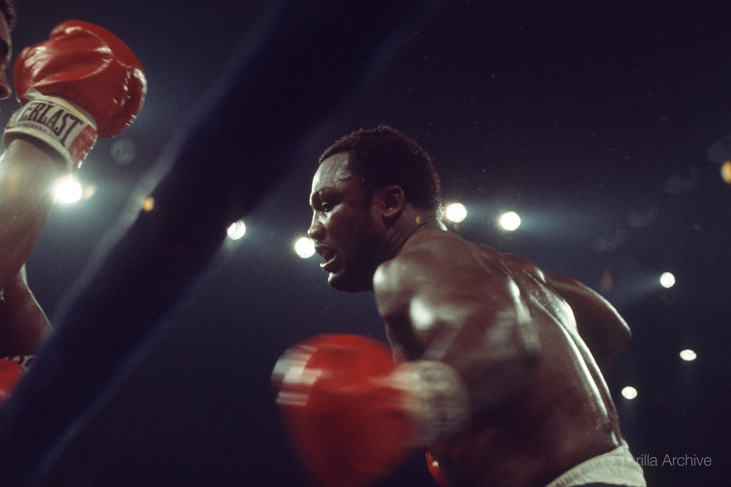 Muhammad Ali braces for incoming violence at the hands of Joe Frazier during their historic bout in the Philippines, the Thrilla in Manila, 1975, photographed by Lowell K. Riley