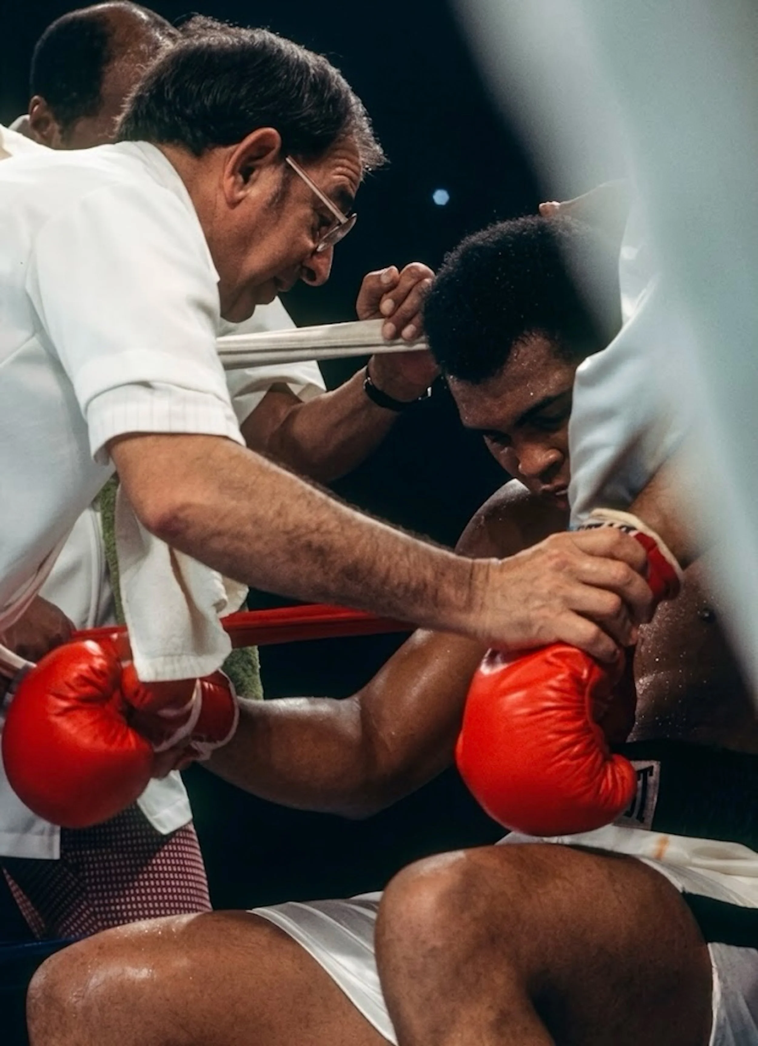 An exhausted Muhammad Ali sits in his corner as trainer Angelo Dundee speaks to him between rounds during Ali-Frazier III, the Thrilla in Manila.