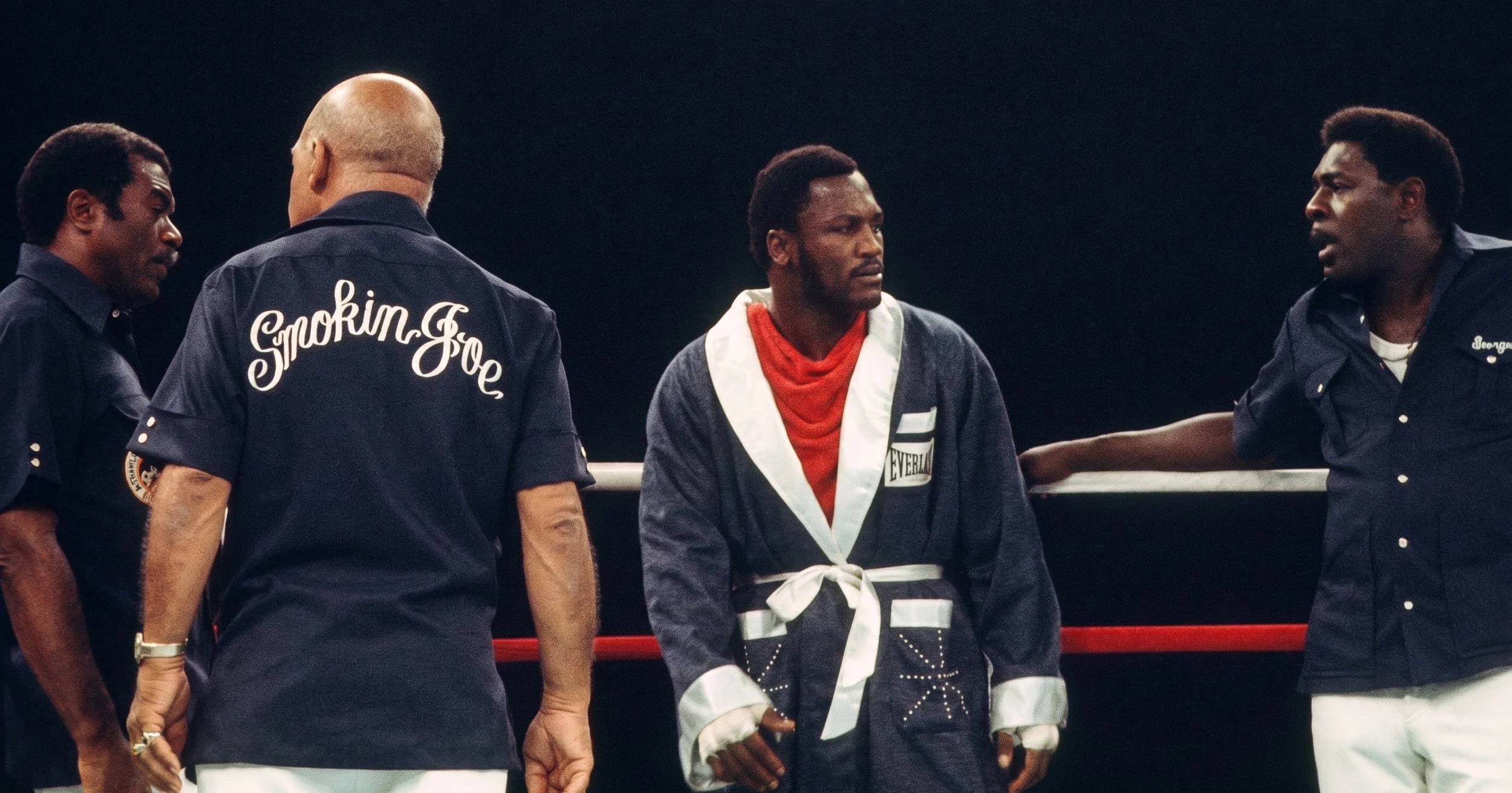 Joe Frazier stands in his corner with his hands wrapped before Ali-Frazier III, surrounded by Eddie Futch, Milt Bailey, and George Benton.