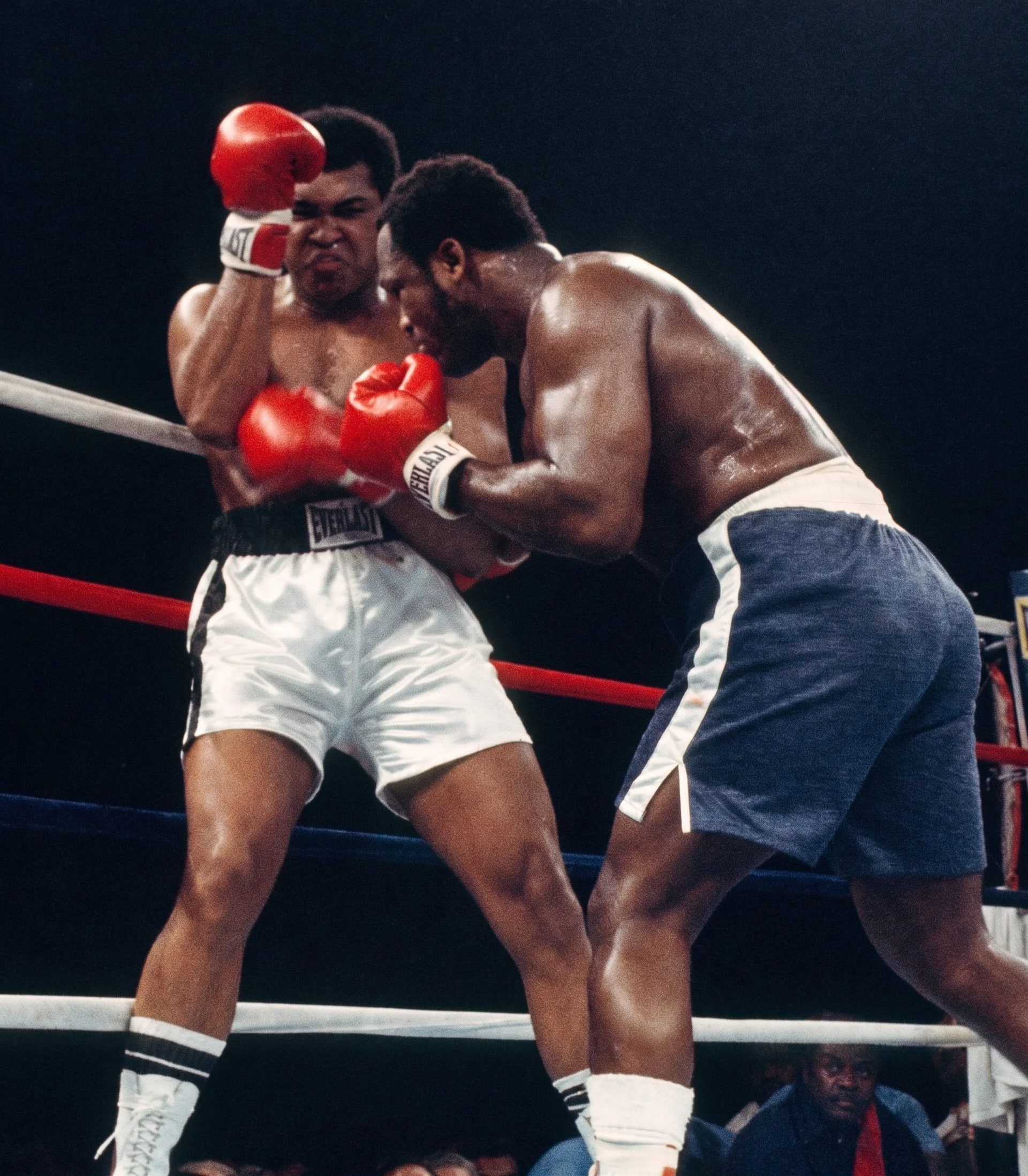 Joe Frazier crowds Muhammad Ali along the ropes during Ali-Frazier III as trainer Eddie Futch watches from Frazier’s corner.