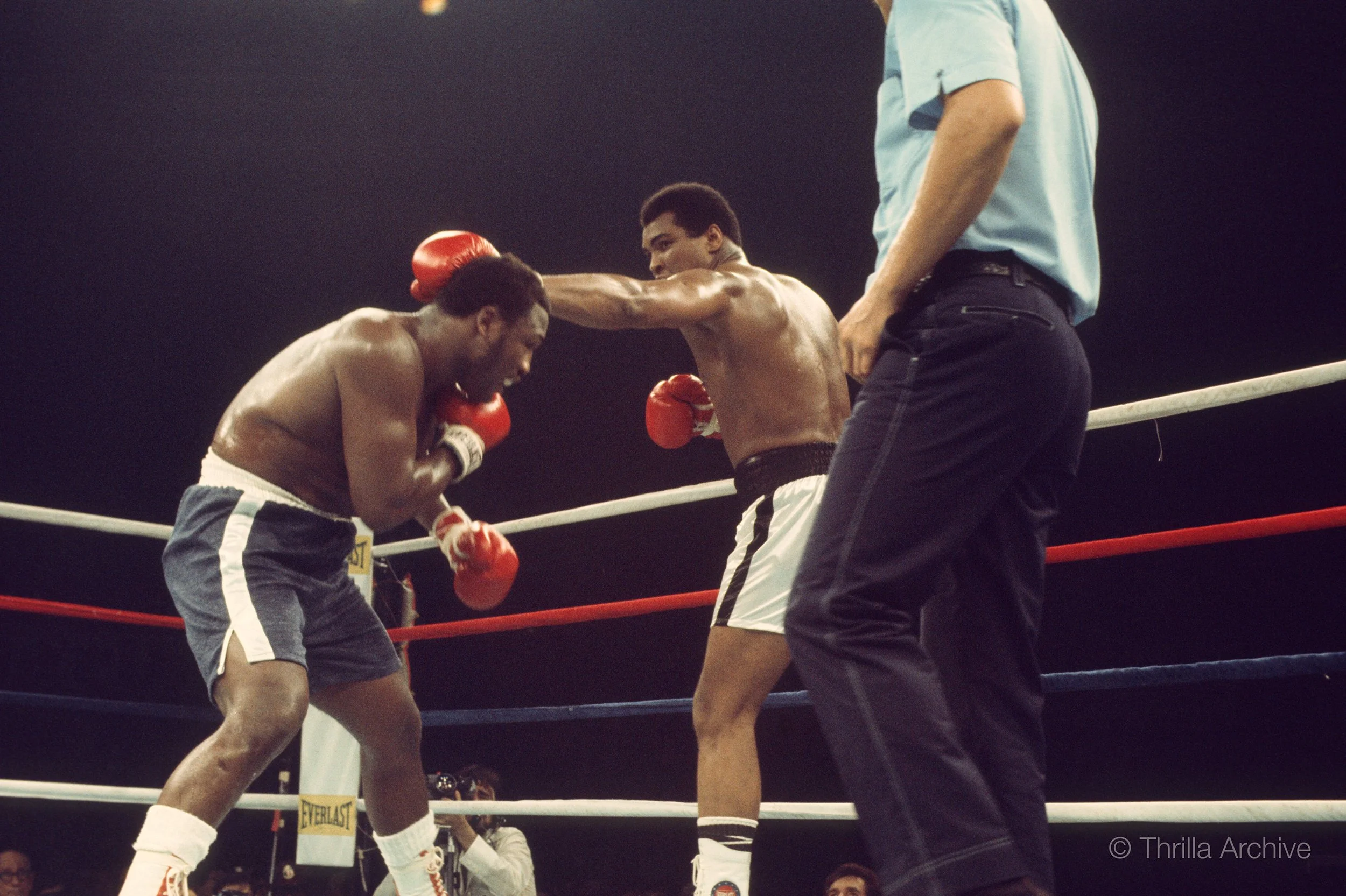 Muhammad Ali measures and fends off Joe Frazier along the ropes in their rubber match, the Thrilla in Manila, 1975