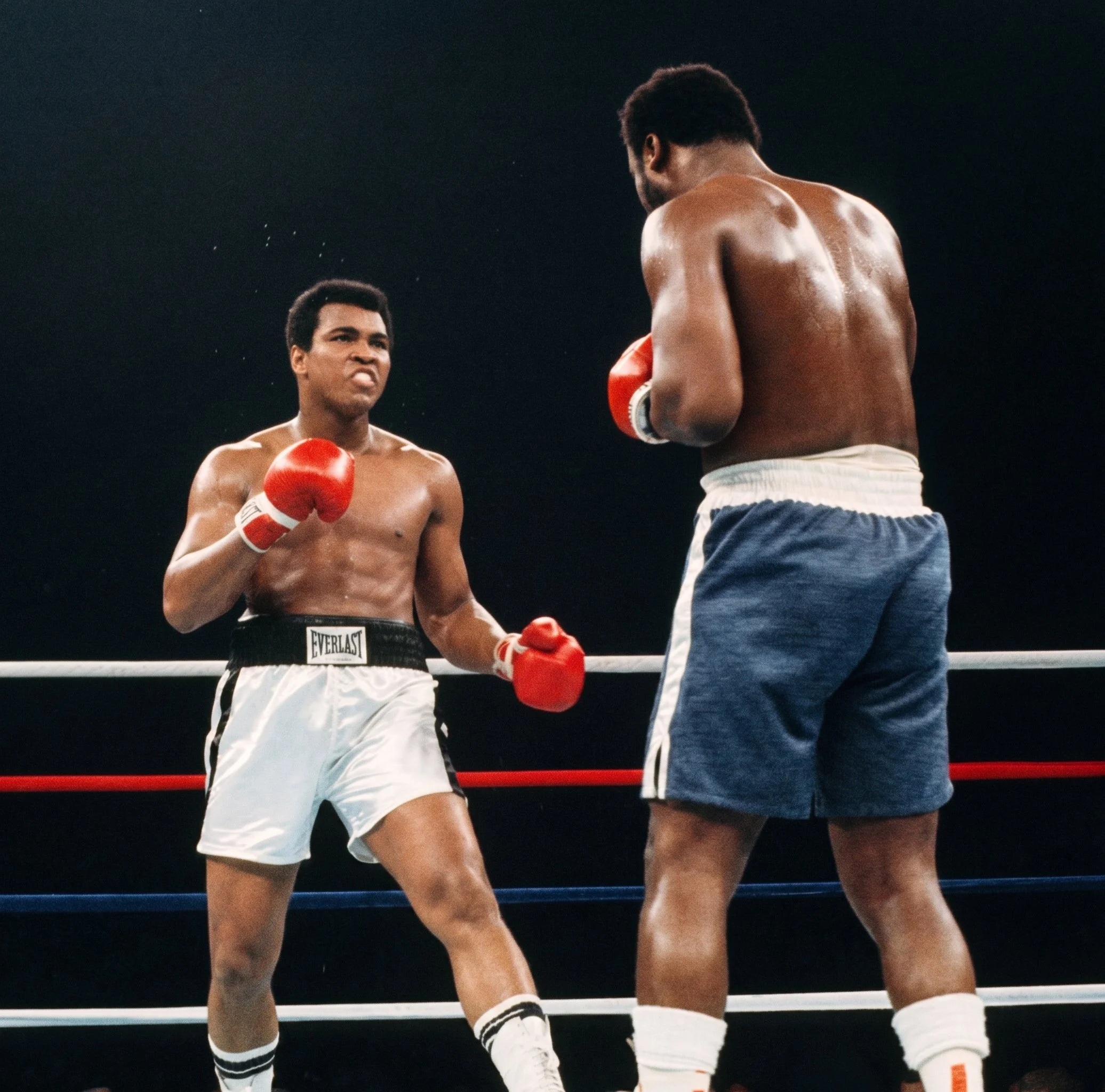 Muhammad Ali faces Joe Frazier with his left hand held low as Frazier advances behind his guard during Ali-Frazier III, the Thrilla in Manila.