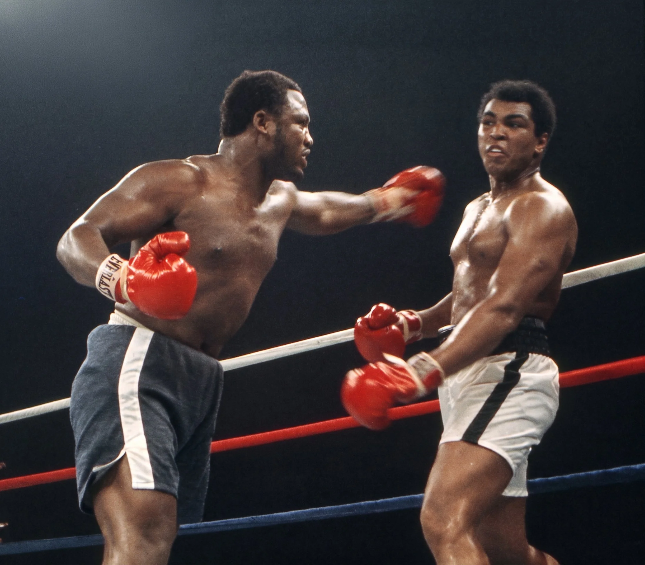 Joe Frazier throws his signature left hook toward Muhammad Ali as Ali pulls back near the ropes during the Thrilla in Manila.