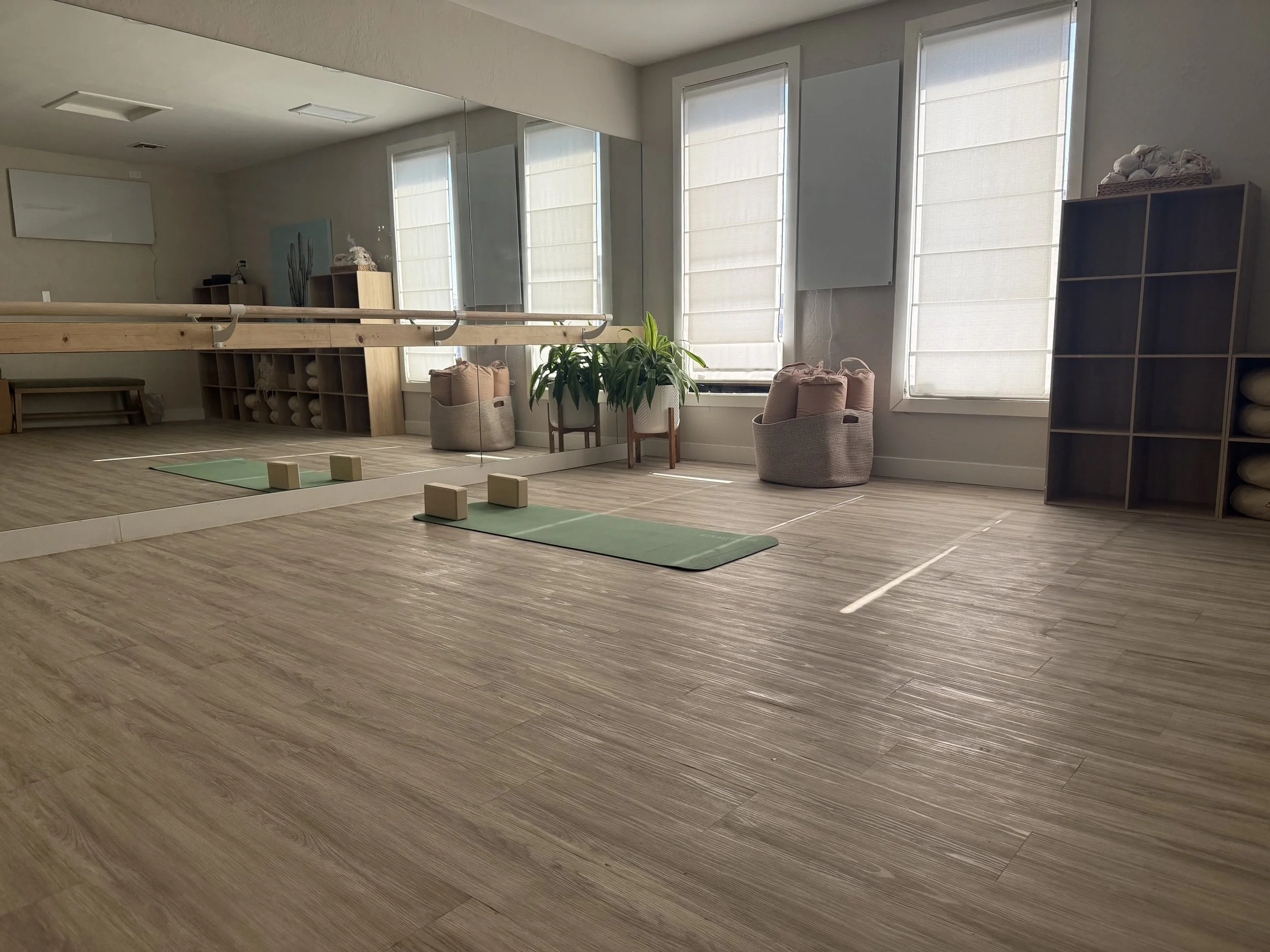 Yoga mats arranged in the welcoming Movement Studio at Stillpoint Wellness in North Phoenix, Arizona, offering small boutique-style yoga and fitness classes.