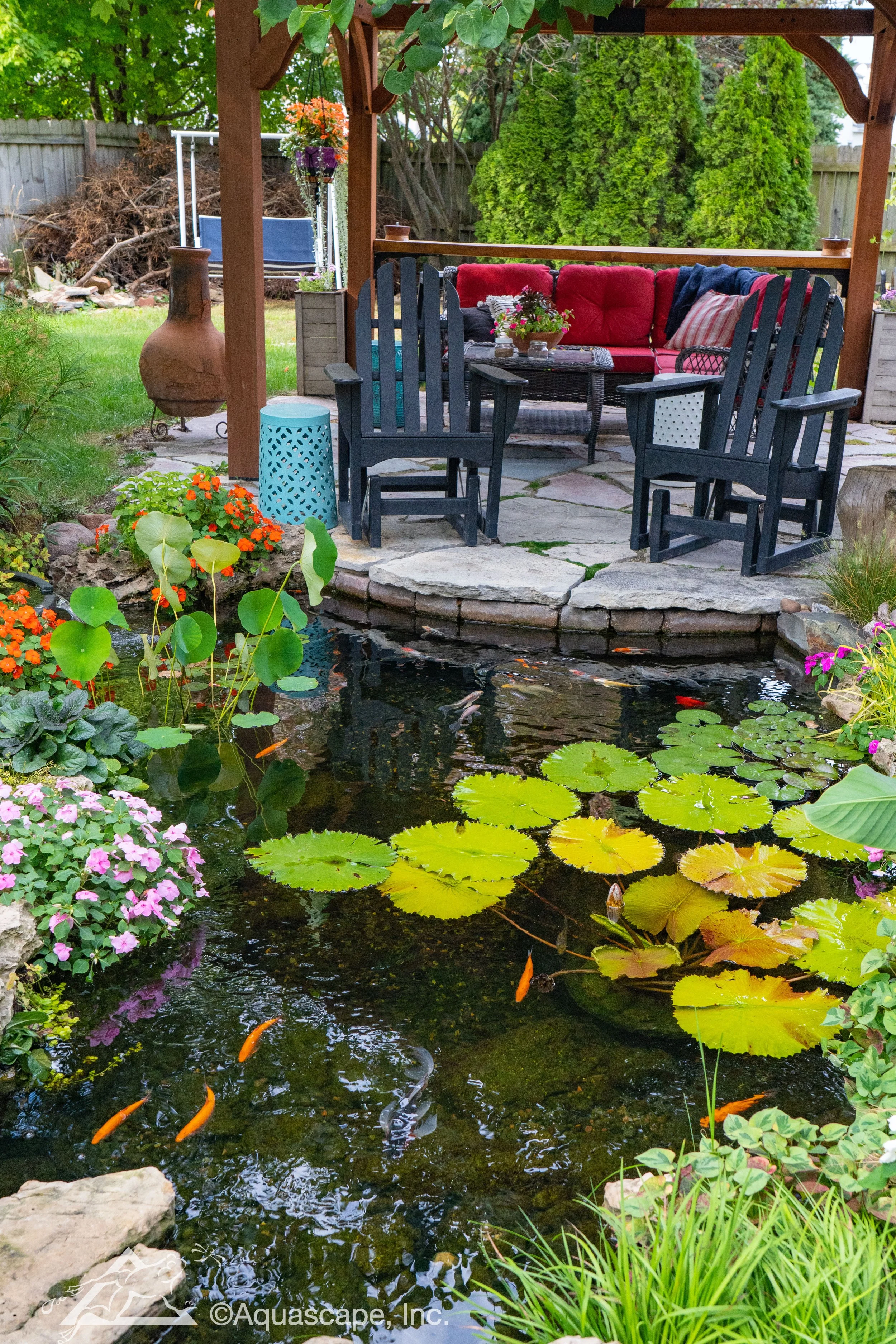 Ecosystem pond with goldfish and patio with patio furniture