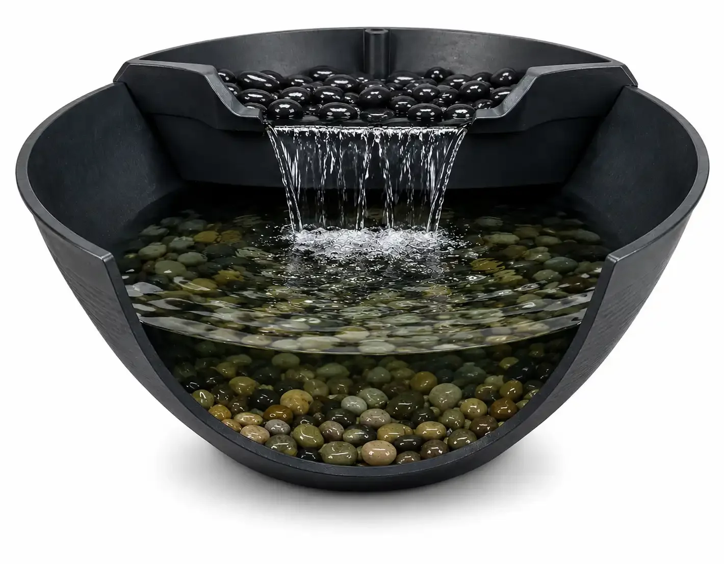 A black zen water fountain with small black stones on the top and larger multicolored stones at the bottom, with water cascading from the top layer into the lower reservoir.