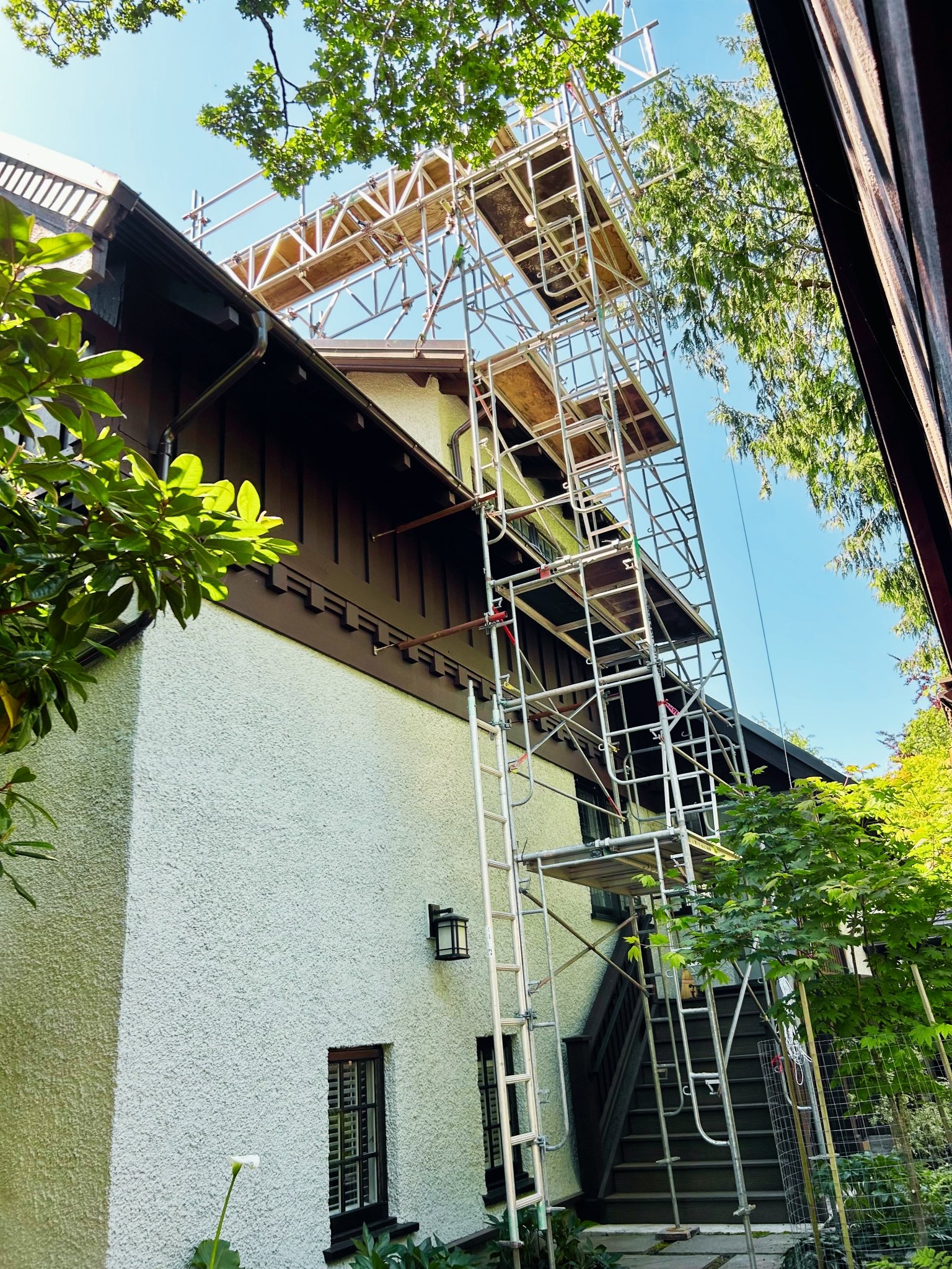 Metal scaffolding installation on a residential home exterior by Summit Scaffolding Services Ltd for roof, chimney and siding repairs in Victoria, BC