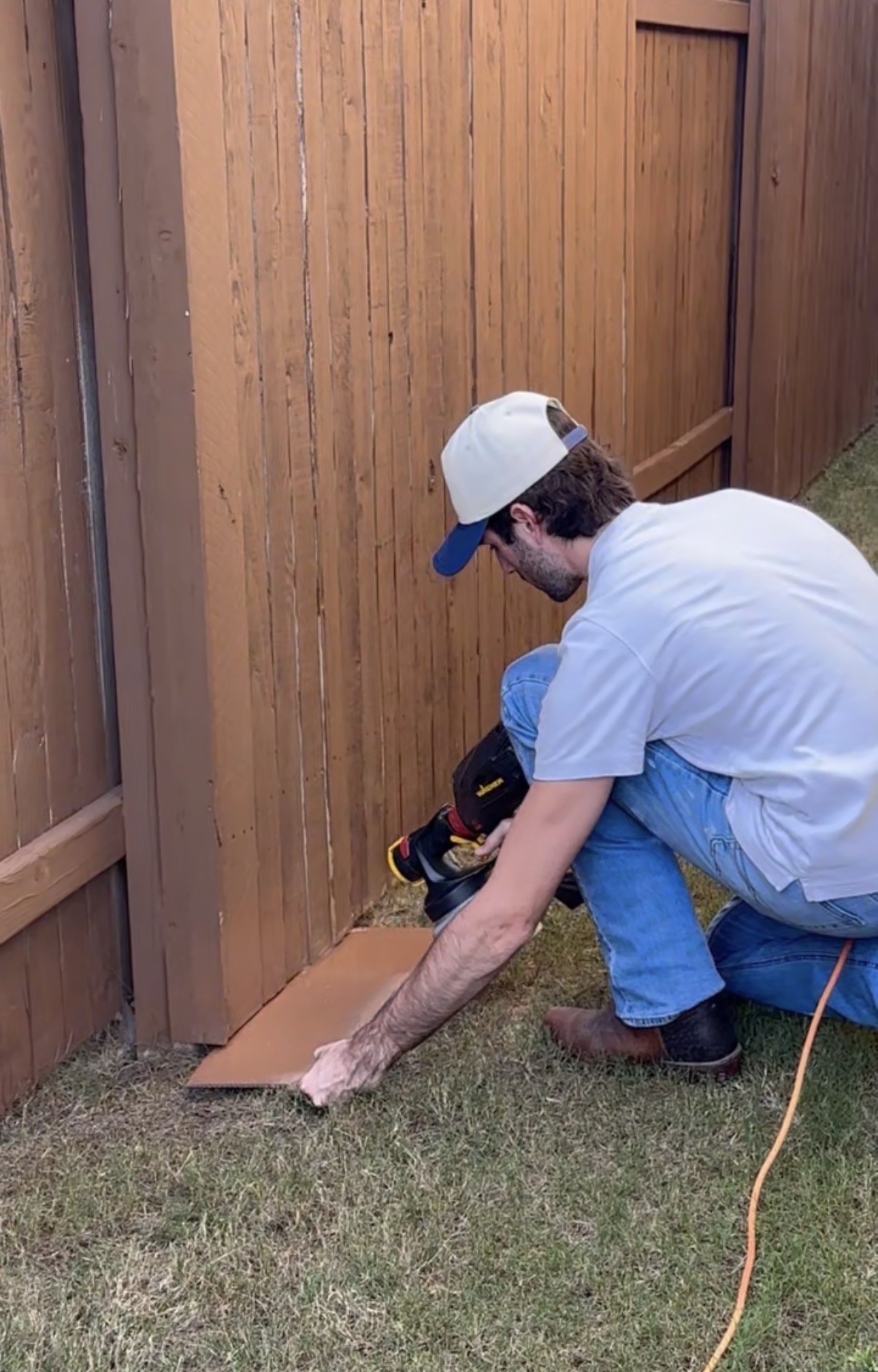 Carter from Golden Hour Painters Staining a Fence with HOA approved color in South Austin