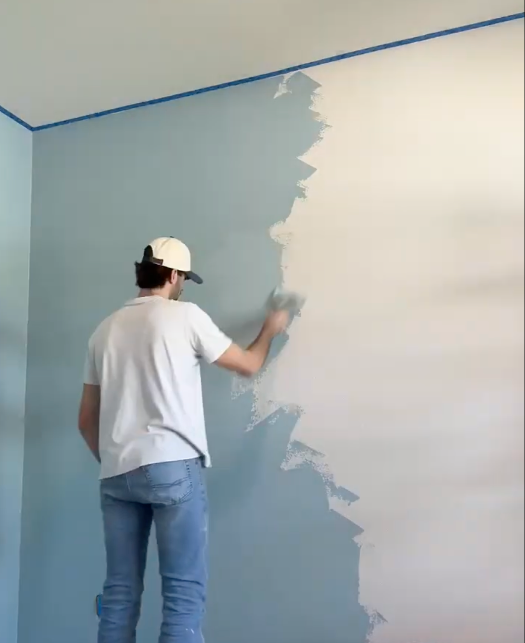 Carter from Golden Hour Painters applying paint to an interior wall in Buda, Texas.