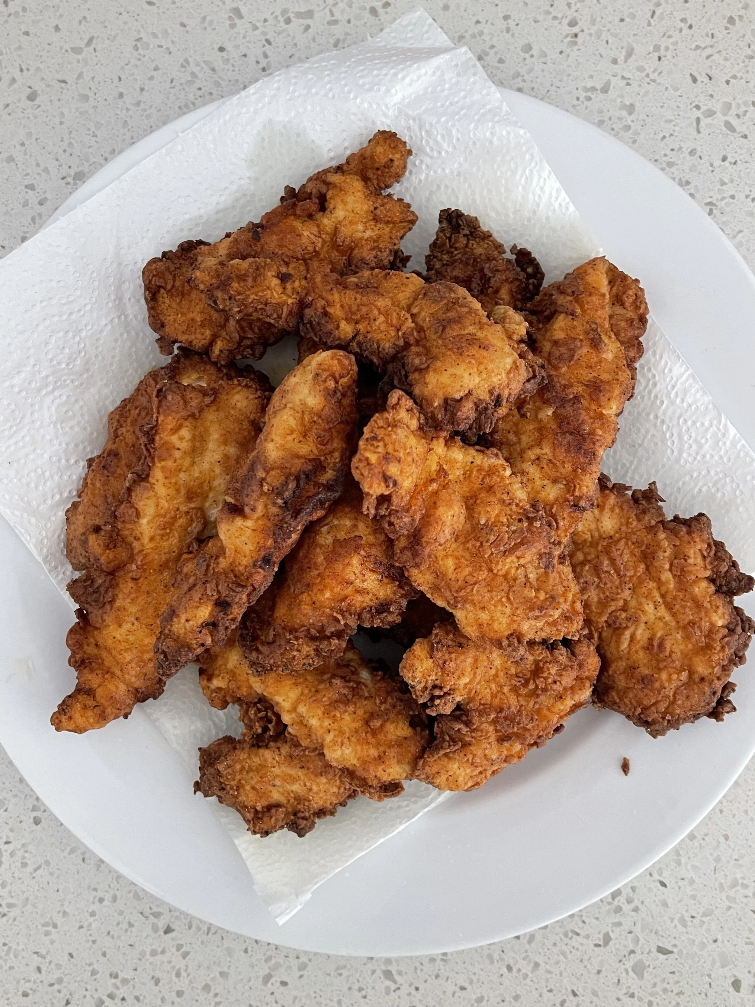 Crispy fried chicken pieces served on a plate, close up food photography for Sierra Series