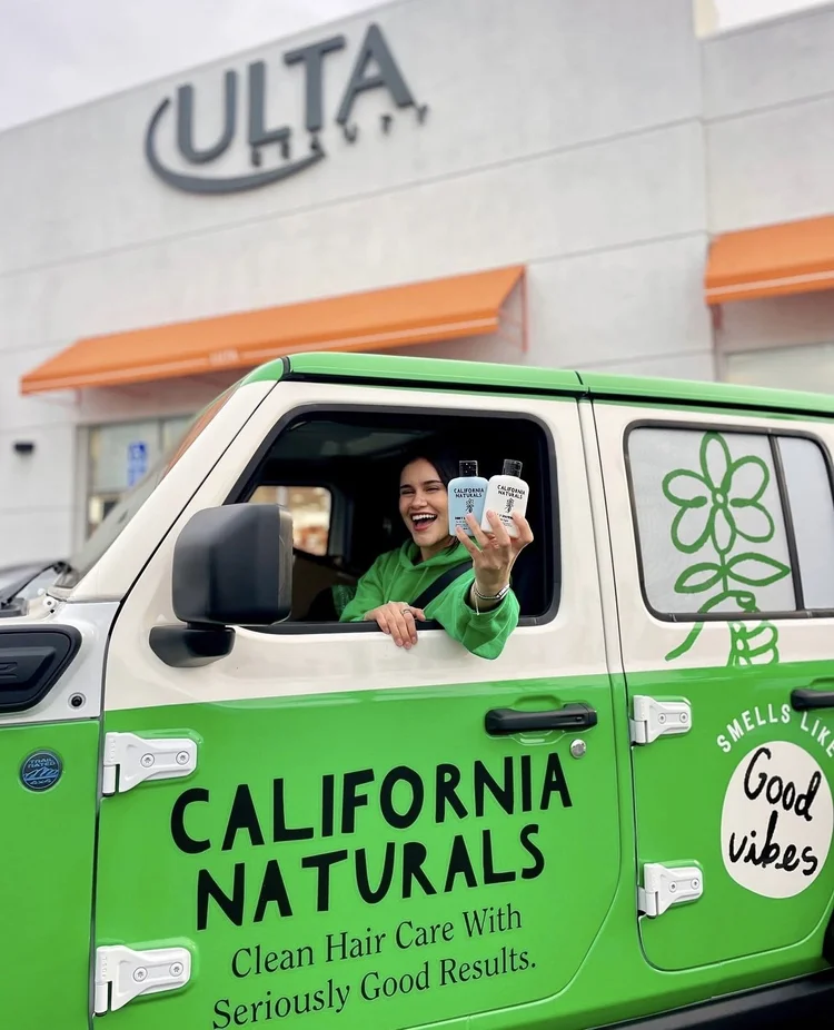 Ambassador in a green California Naturals-wrapped vehicle outside an Ulta store