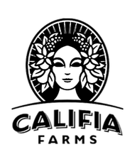 Black and white photograph of a baby sleeping on a bed with a blanket.