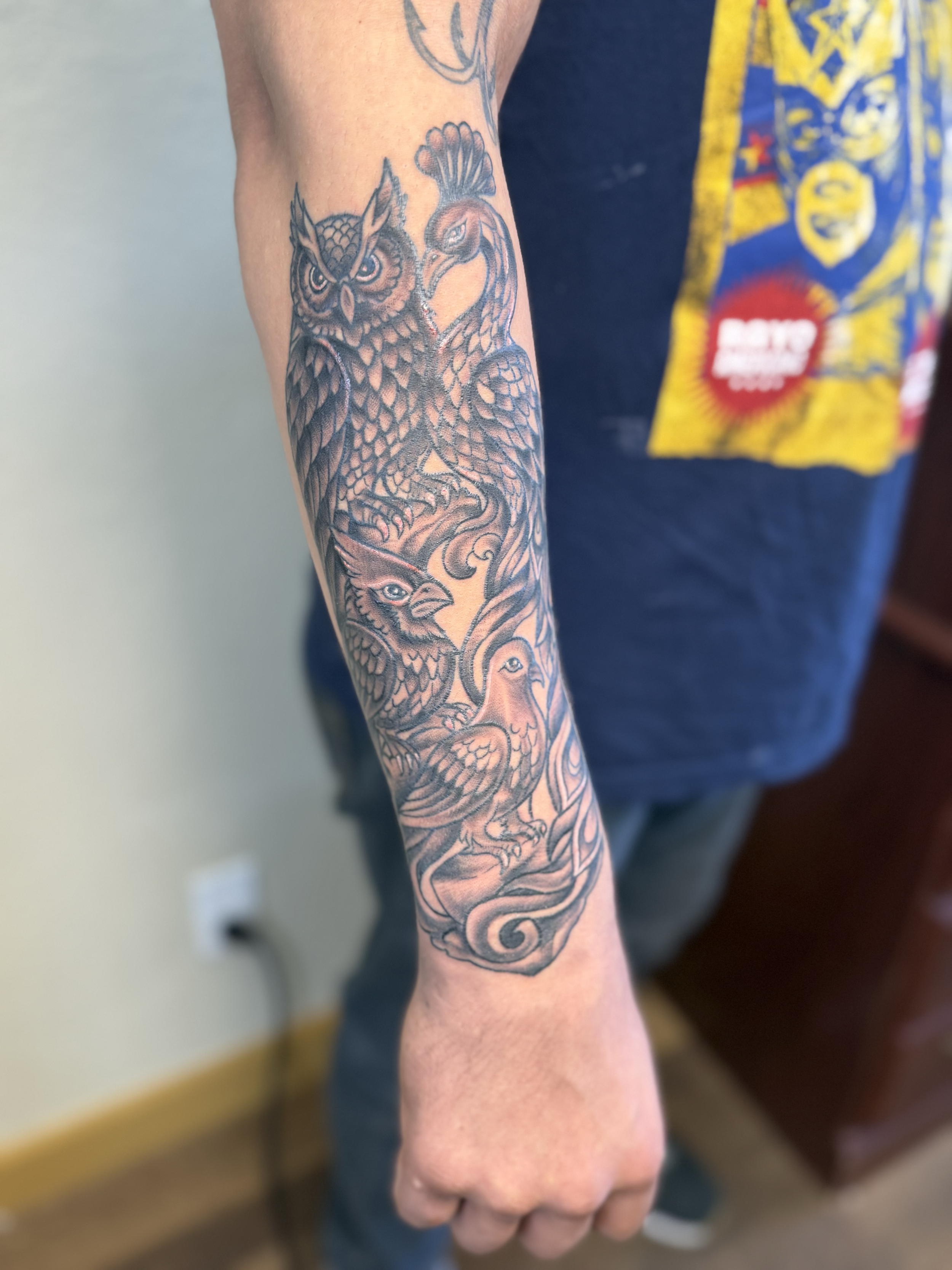 Black and gray bird sleeve tattoo on forearm, Lago Vista TX