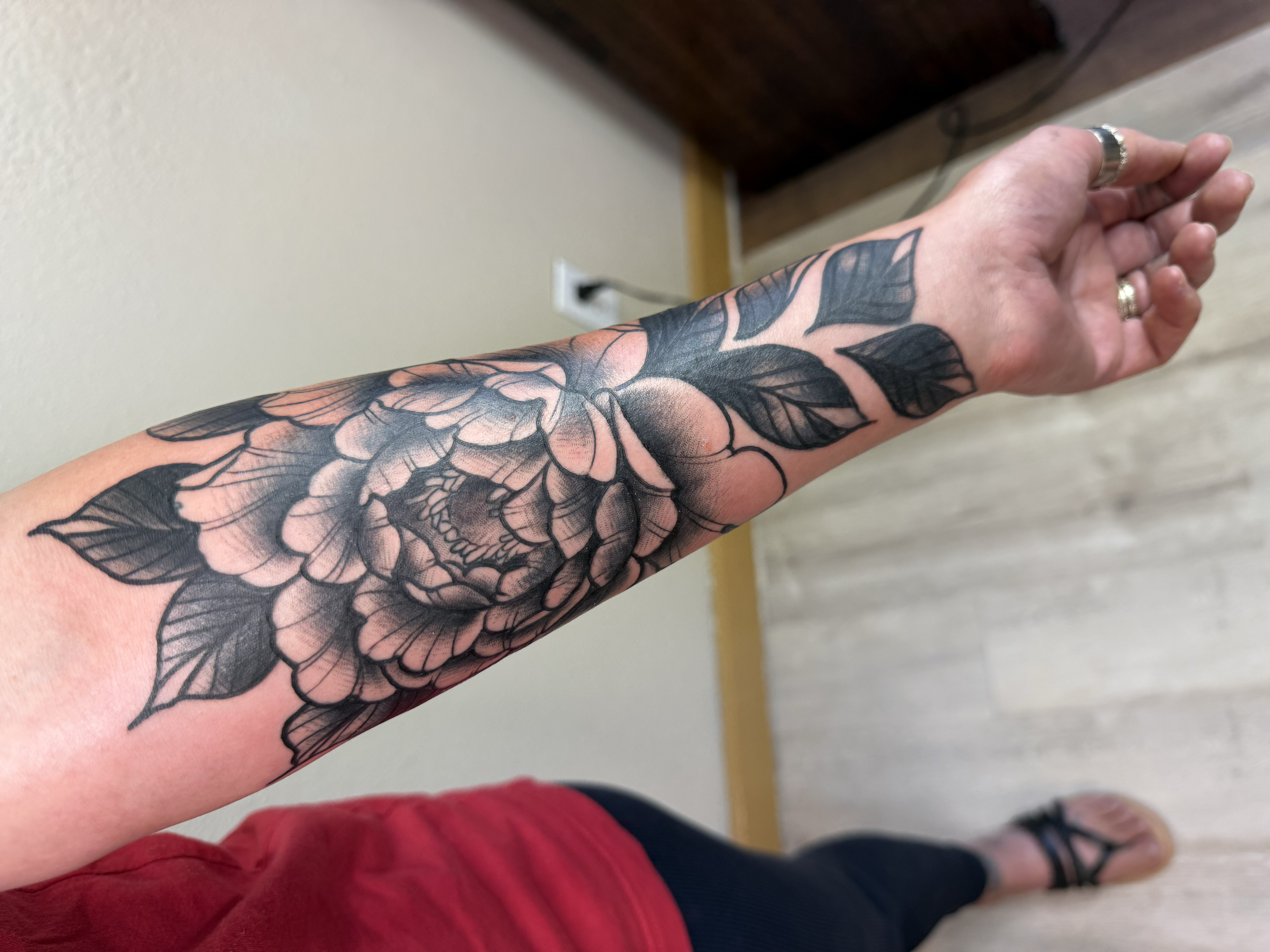 Black and gray peony tattoo on forearm, Lago Vista TX