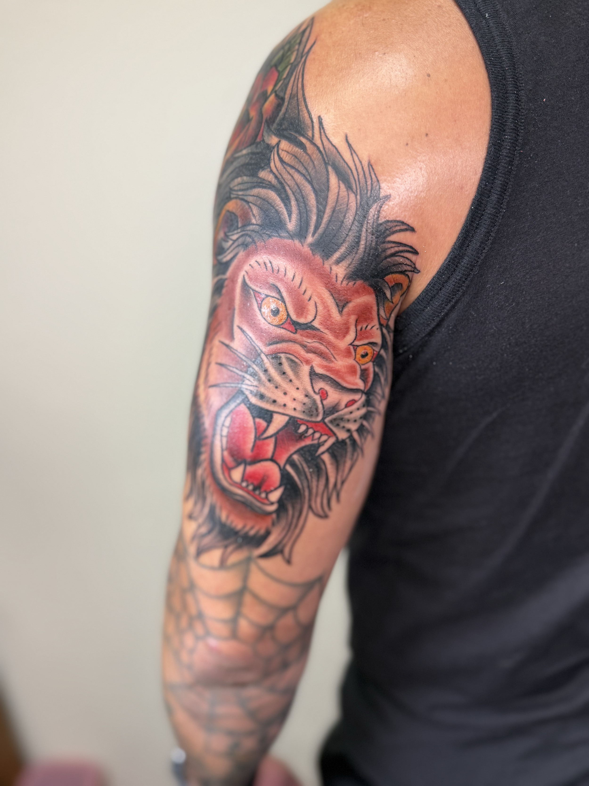 Red lion head tattoo on upper arm, Lago Vista TX