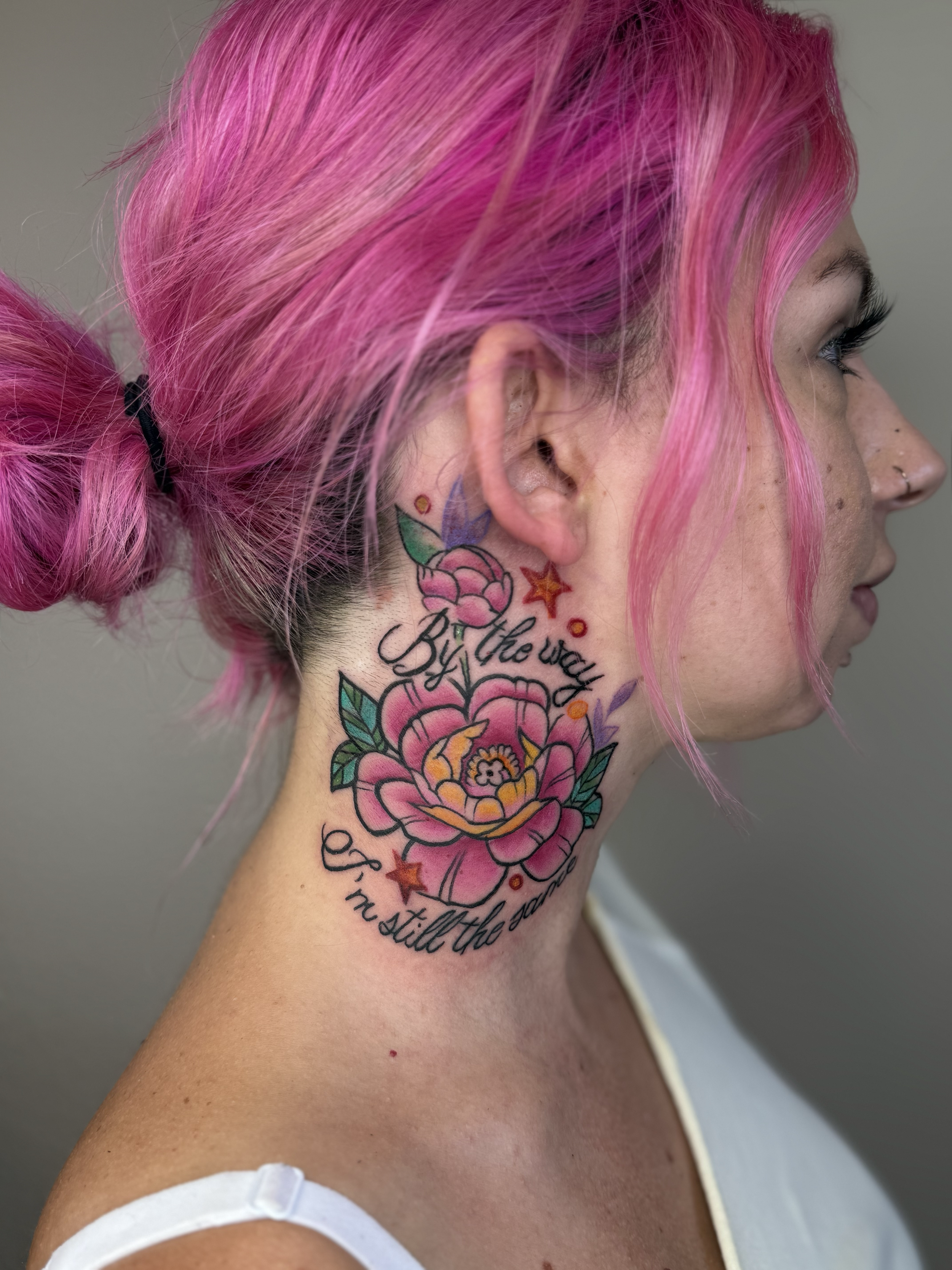 Color flower and script tattoo on neck, Lago Vista TX