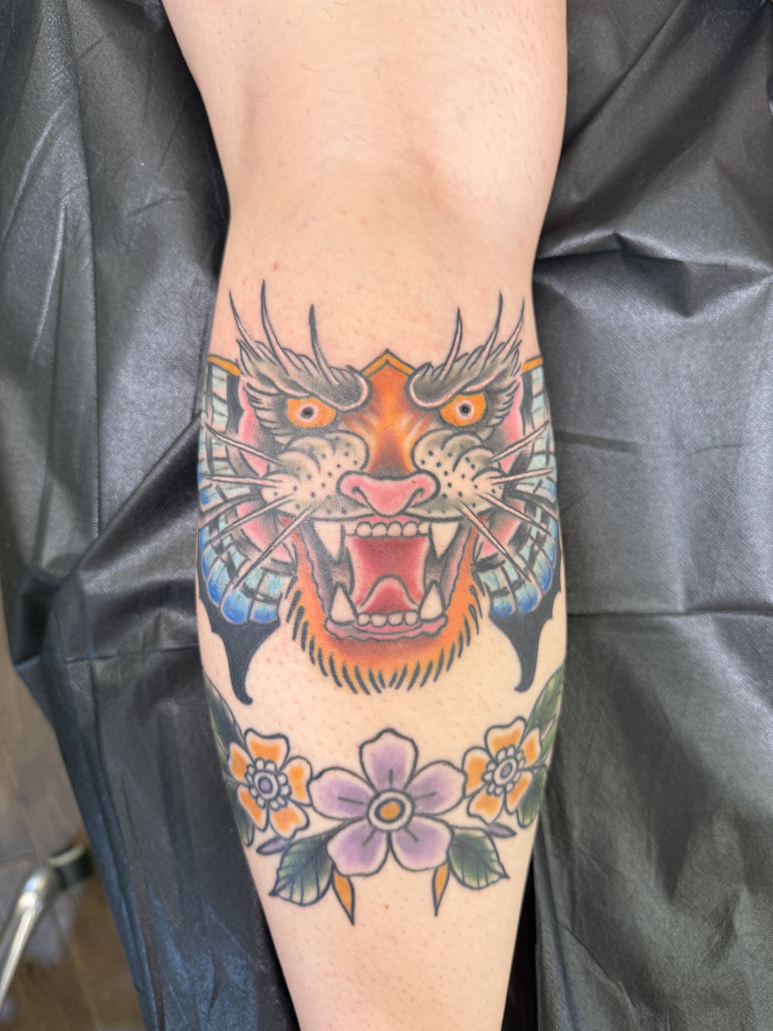Traditional tiger head and flower tattoo on arm, Lago Vista TX