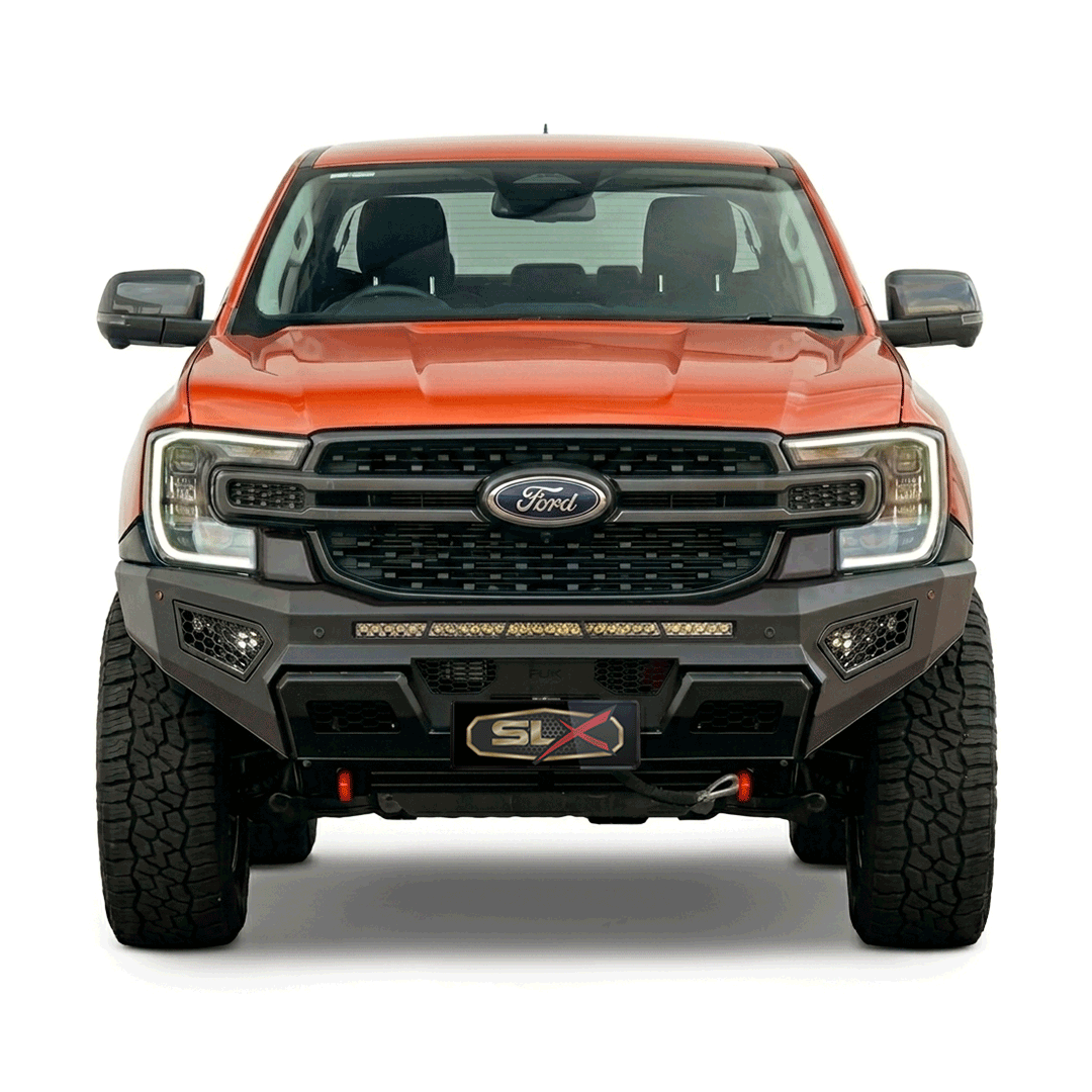 Front view of a black and orange Ford F-150 truck with off-road tires and SLX license plate.