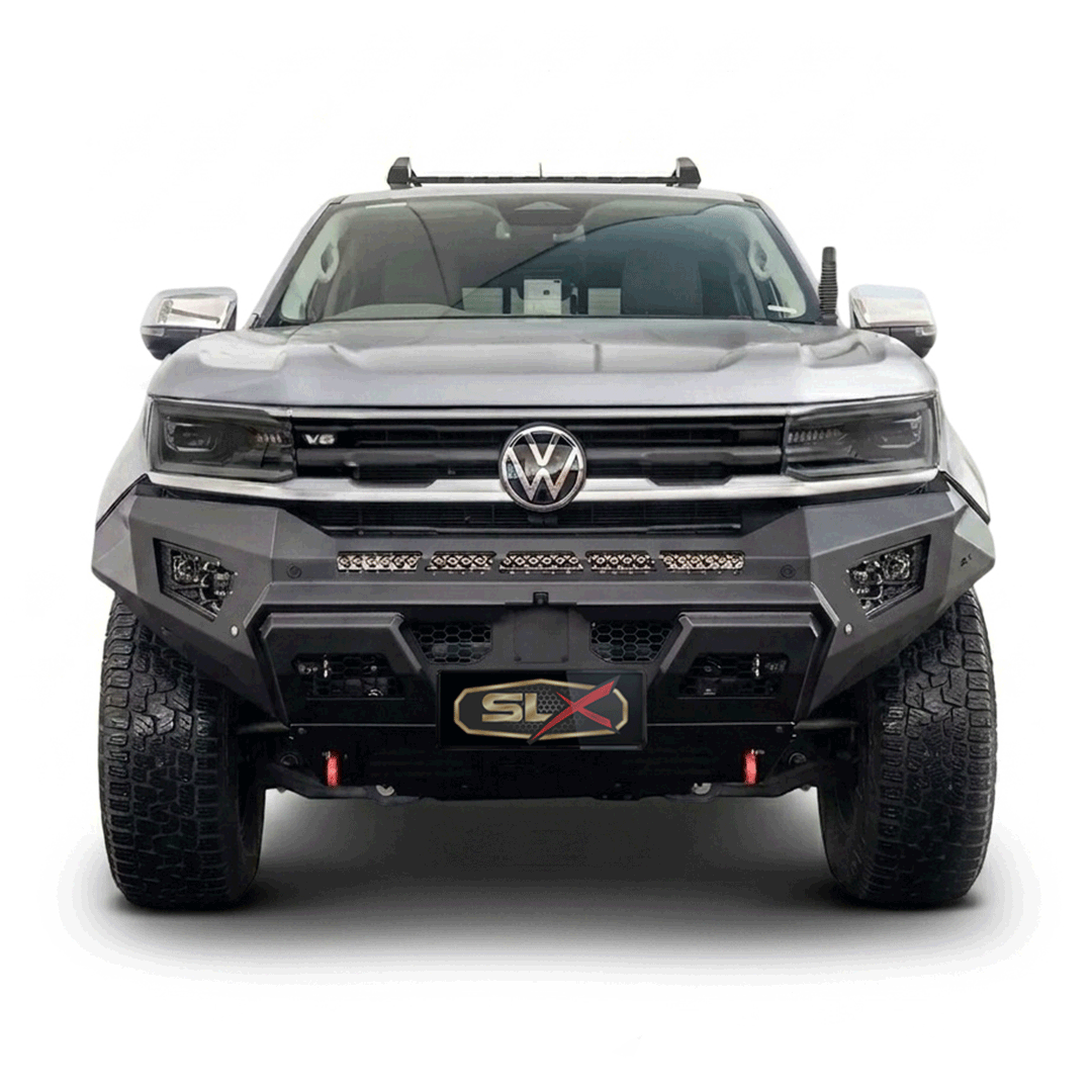 Front view of a modified silver Volkswagen truck with aggressive styling, off-road tires, and a custom bumper.