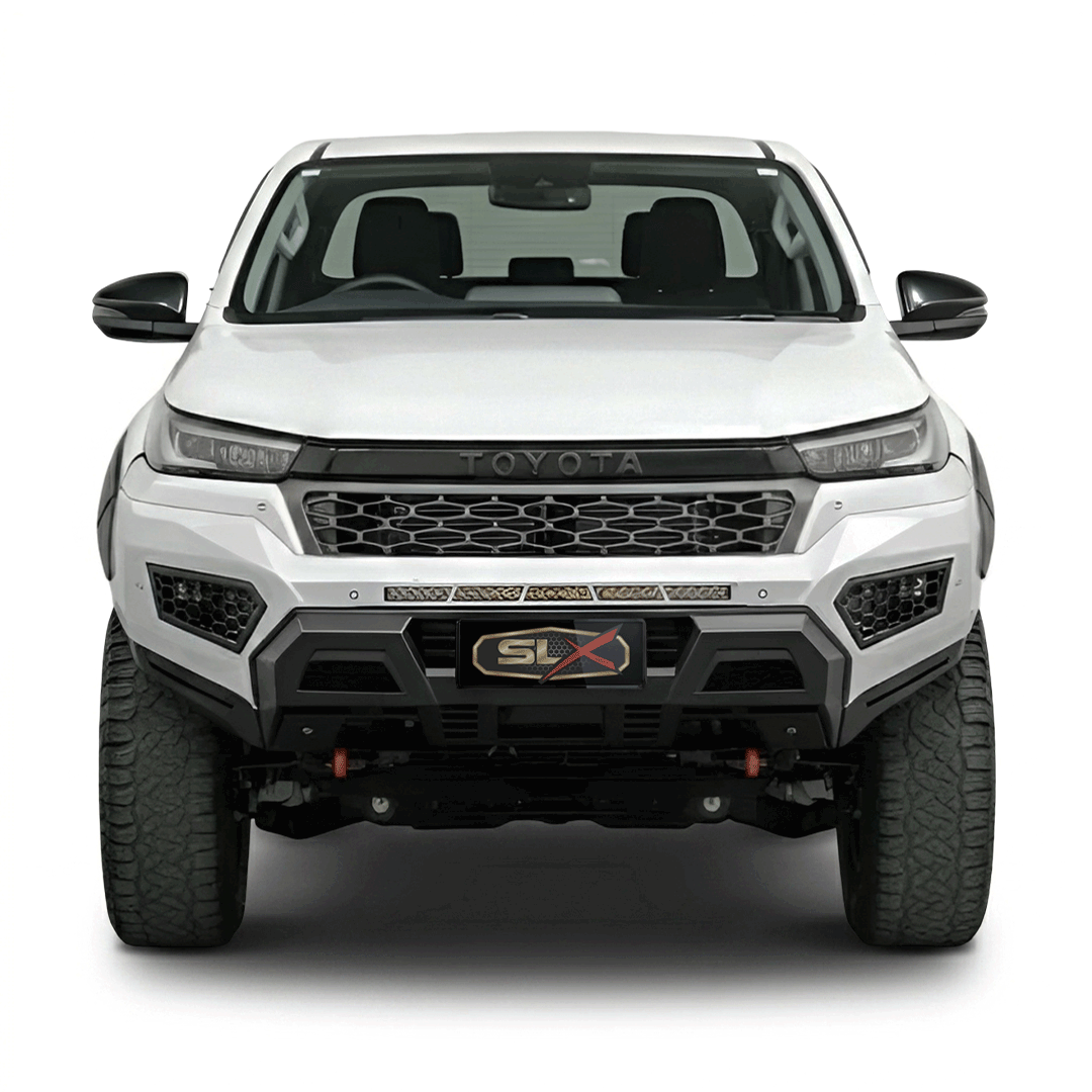 Front view of a white off-road Toyota truck with black accents and large tires.